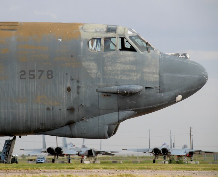 A worn down B-52G Stratofortress sits on the old Strategic Air Command ramp north of the 80th Flying Training Wing Aug. 24 prior to its dismantling. Navy Facilities Engineering Command, Engineering Center from Port Hueneme, Calif., is overseeing the project to demolish the excess aircraft. The F-15C and D models in the background will soon replace outdated A and B models on Sheppard's Ground Instructional Training Aircraft Ramp. (U.S. Air Force photo/Mike Litteken)