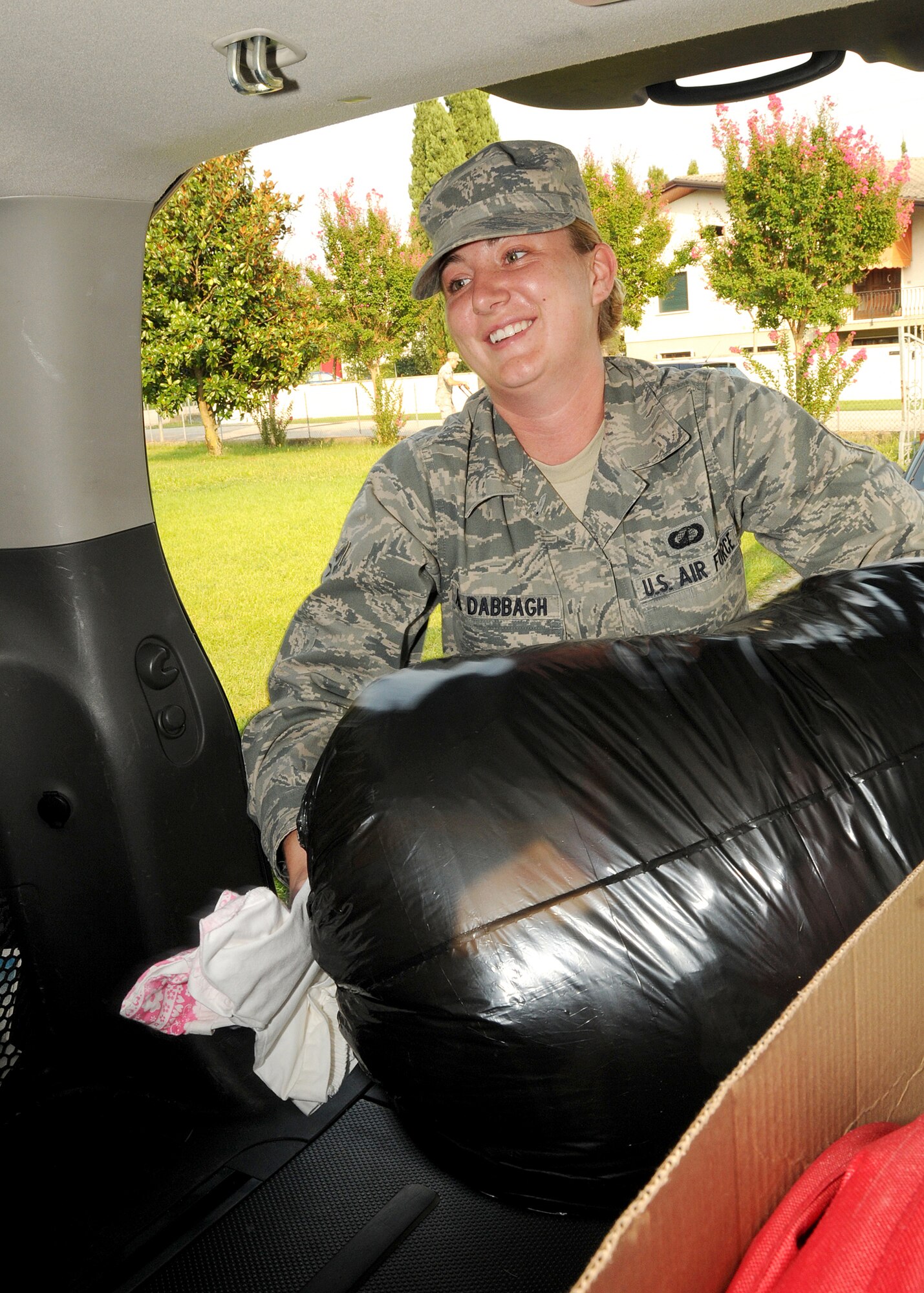Airman 1st Class Anna Maria Al Dabbagh, 31st Contracting Squadron contracting specialist, loads donation items into a vehicle Aug. 24.  Aviano Airmen's Advisory Council Airmen will be providing services, including painting, packing, lifting, cleaning and maintaining lawns  as part of Airmen Support for Families project.  (U.S. Air Force photo/Senior Airman Tabitha M. Lee)