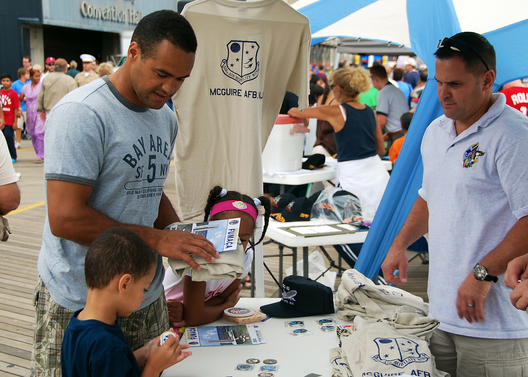 ATLANTIC CITY, N.J. ? Chief Master Sgt. Todd Harris (right) of the 714th Aircraft Maintenance Squadron works at a souvenir booth at an air show in Atlantic City, N.J., Aug. 25, 2010. Chief Harris and other member of the 514th Air Mobility Wing Chiefs Group sell souvenirs to raise money to fund programs that assist the wing?s Airmen. 