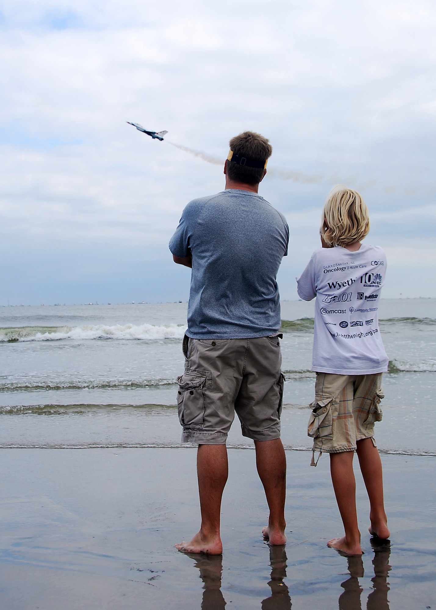 ATLANTIC CITY, N.J. ? A father and son stand in the surf while observing the flight of an Air Force Thunderbird during the ?Thunder over the Boardwalk? air show in Atlantic City, N.J., Aug. 25, 2010.  The Thunderbirds, who are the Air Force?s top demonstration team, fly F-16 Fighting Falcons.