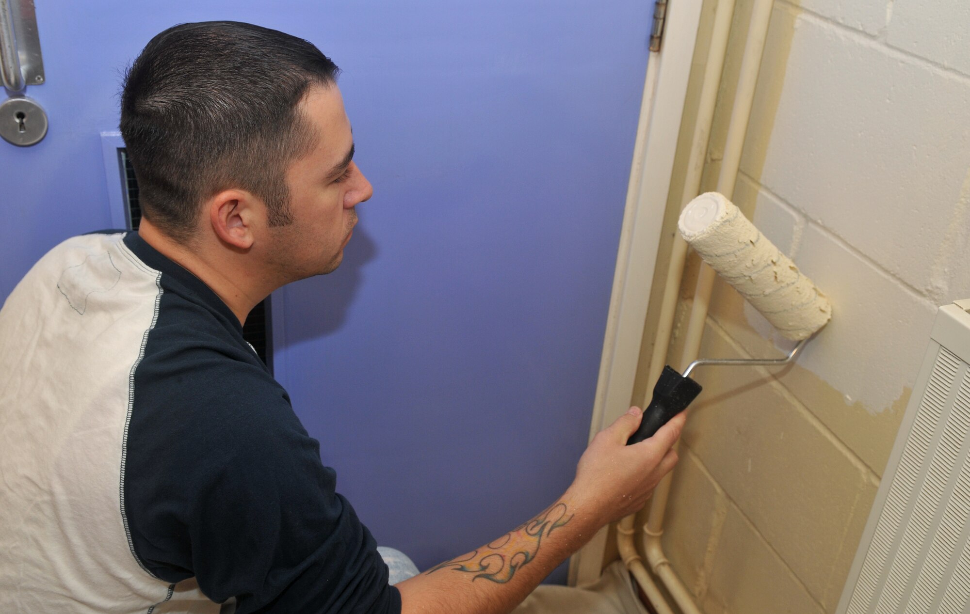 Master Sgt. Michael Standring, 352nd Special Operations Support Squadron, paints a window sill at Beck Row Primary School, near RAF Mildenhall, Aug. 26, 2010. While sweeping, cleaning and painting was the obvious agenda for the group, the intangible impacts will last far beyond the paint's applied lifetime. (US Air Force photo/Tech. Sgt. Kevin Wallace)