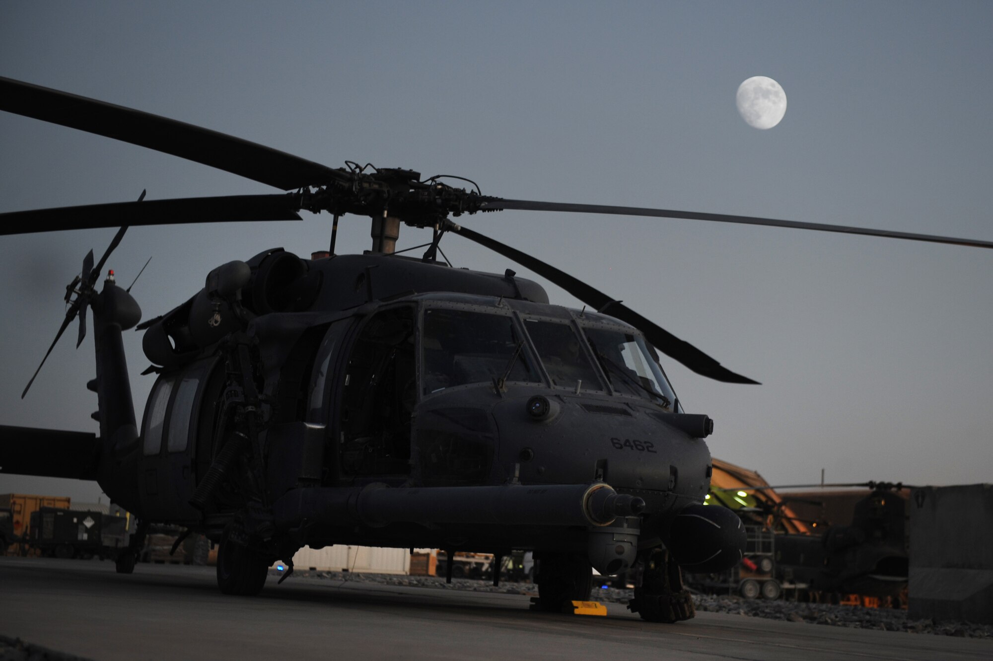 A double exposed photograph shows a nearly full moon illuminating an HH-60G Pave Hawk helicopter during the month of Ramadan at Kandahar Airfield, Afghanistan, Aug. 23, 2010. The 26th Expeditionary Rescue Squadron uses the Pave Hawk for casualty evacuation missions, as well as to transport injured coalition and Afghan service members and civilians for medical treatment.  The month of Ramadan begins with the sighting of the Hilal, or crescent, moon. (U.S. Air Force photo by Tech. Sgt. Chad Chisholm/Released) 