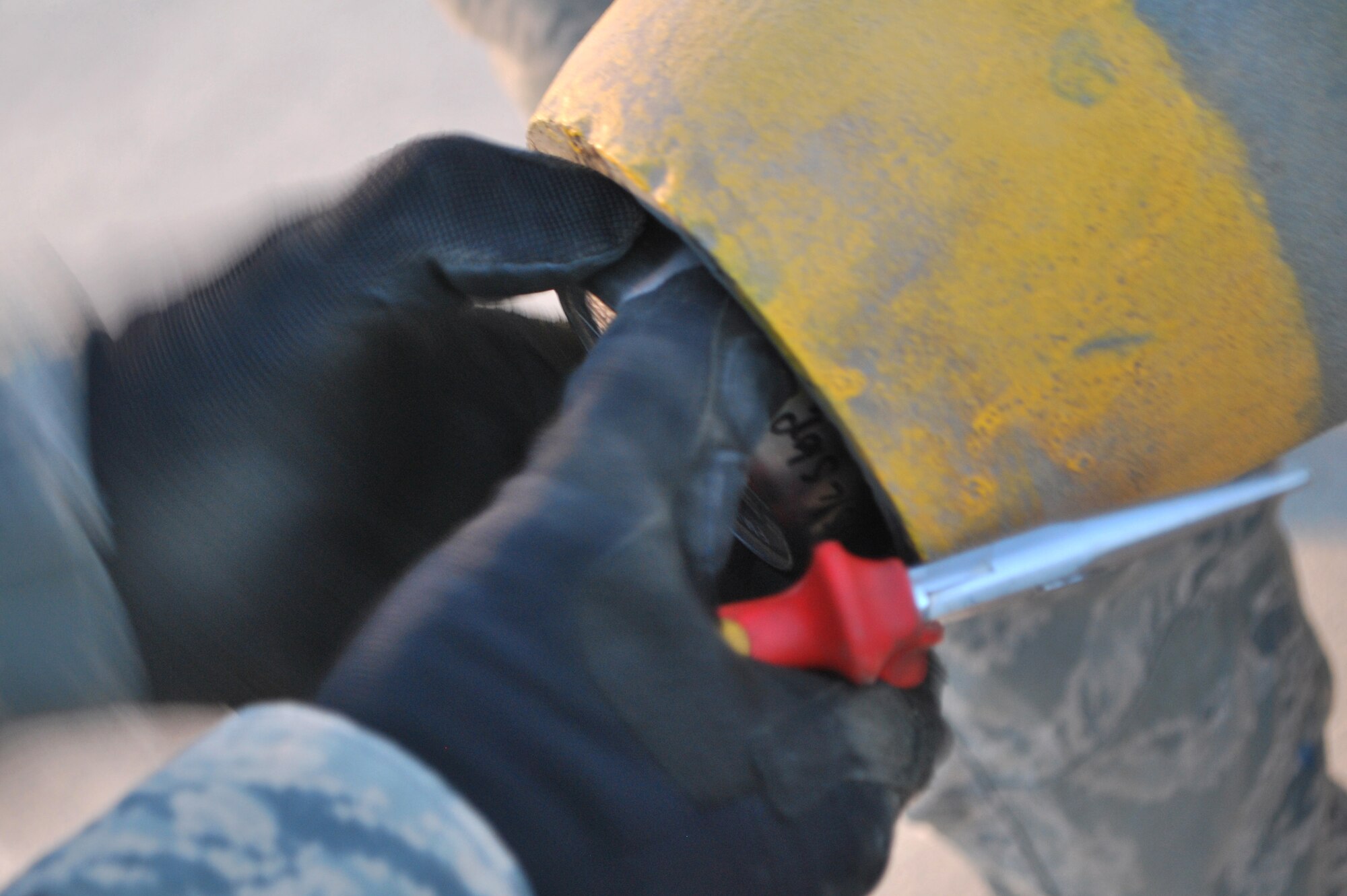 Staff Sgt. Jeremiah Smartt adjusts the fuse inside a bomb Aug. 23 at Kandahar Airfield, Afghanistan.  Sergeant Smartt is a conventional maintenance crew chief with the 451st Expeditionary Maintenance Squadron Munitions Flight. (U.S. Air Force photo by Senior Airman Melissa B. White/Released)