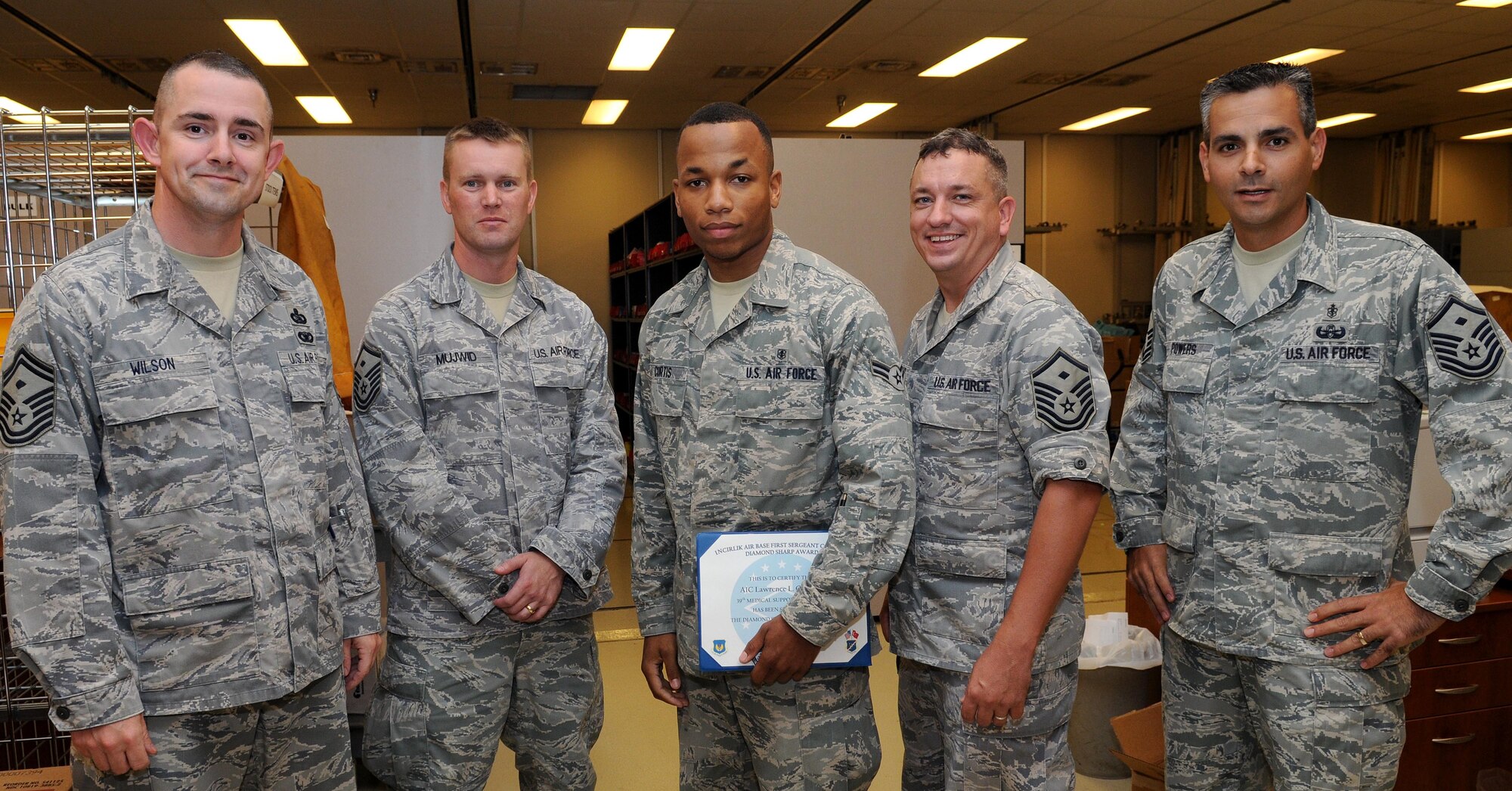 Airman 1st Class Lawrence Curtis III, 39th Medical Support Squadron, poses for a photo with first sergeants after receiving the 'Diamond Sharp' award from the Incirlik First Sergeants Council Aug. 24, 2010 at Incirlik Air Base, Turkey.  Airman Curtis was nominated for the award by Master Sgt. Robert Powers Jr, 39th Medical Group first sergeant, for distinguishing himself through outstanding professionalism, performance and display of the Air Force core values. (U.S. Air Force photo/ Senior Airman Ashley Wood)
