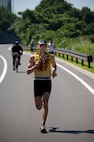 MISAWA AIR BASE, Japan -- Maj. David Kempisty, 35th Aerospace Medicine Squadron bio-environmental engineering flight commander, runs the home stretch of Wild Weasel Triathlon 2010 here, Aug. 21. Major Kempisty finished sixth in the men's open category with a time of 51 minutes, 40 seconds. (U.S. Air Force photo/Staff Sgt. Samuel Morse)