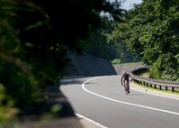 MISAWA AIR BASE, Japan -- Shinya Takahashi bikes through concrete canyon, completing the cycling portion of Wild Weasel Triathlon 2010, Aug. 21. Takahashi won the men's open category with a total time of 45 minutes. Takahashi previously placed first in the 63rd annual Fuji Mountain Race, completing the 21K course and reaching the summit in 2:53:00. (U.S. Air Force photo/Staff Sgt. Samuel Morse)