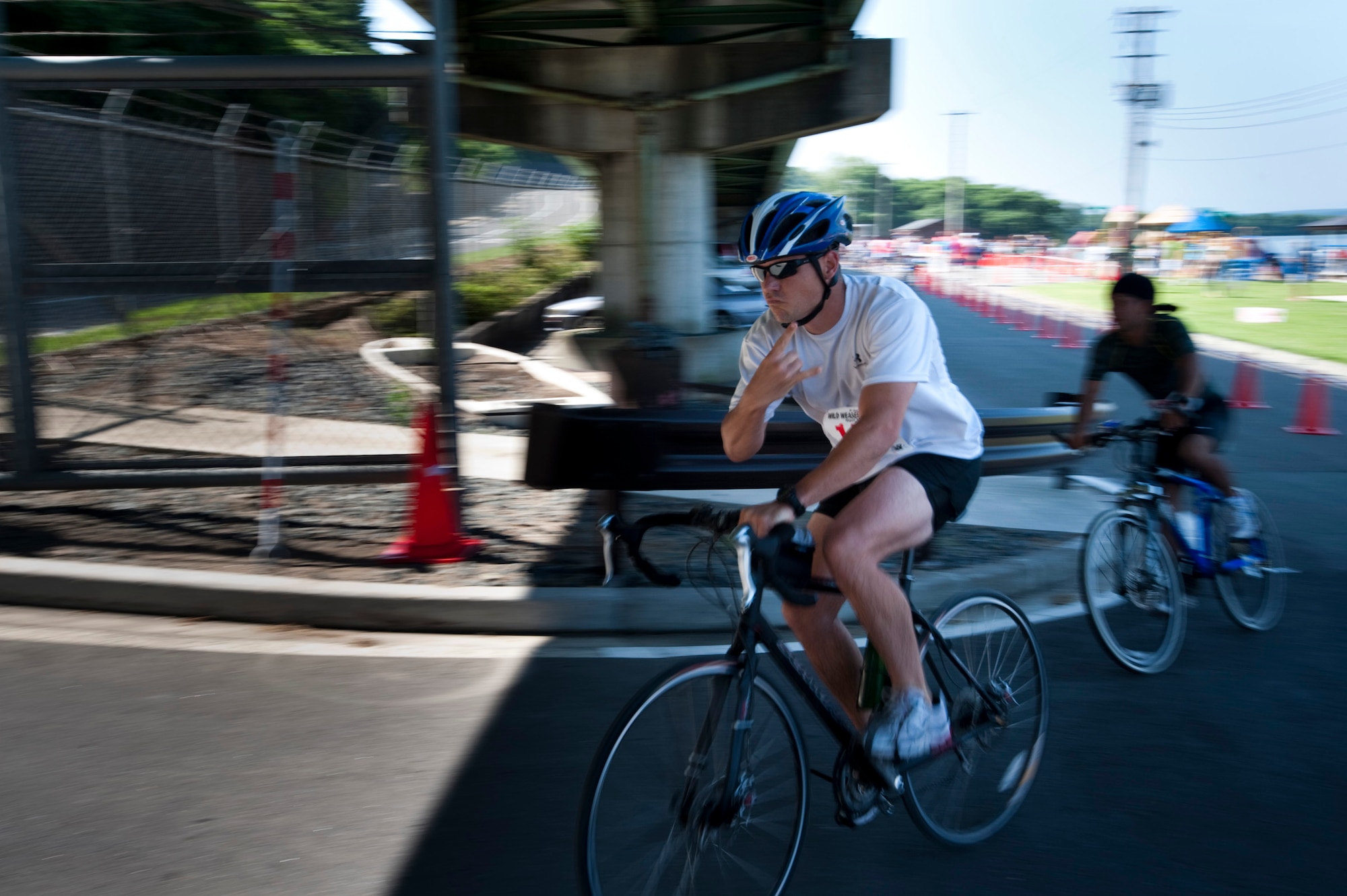 MISAWA AIR BASE, Japan -- Tech. Sgt. Tobin Bryant, 35th Civil Engineer Squadron explosive ordnance disposal technician, begins the cycling portion of Wild Weasel Triathlon 2010, Aug. 21. The adult triathlon consisted of a 400-meter swim, 13K bike ride and a 5K run. (U.S. Air Force photo/Staff Sgt. Samuel Morse)