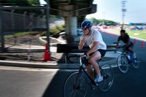 MISAWA AIR BASE, Japan -- Tech. Sgt. Tobin Bryant, 35th Civil Engineer Squadron explosive ordnance disposal technician, begins the cycling portion of Wild Weasel Triathlon 2010, Aug. 21. The adult triathlon consisted of a 400-meter swim, 13K bike ride and a 5K run. (U.S. Air Force photo/Staff Sgt. Samuel Morse)