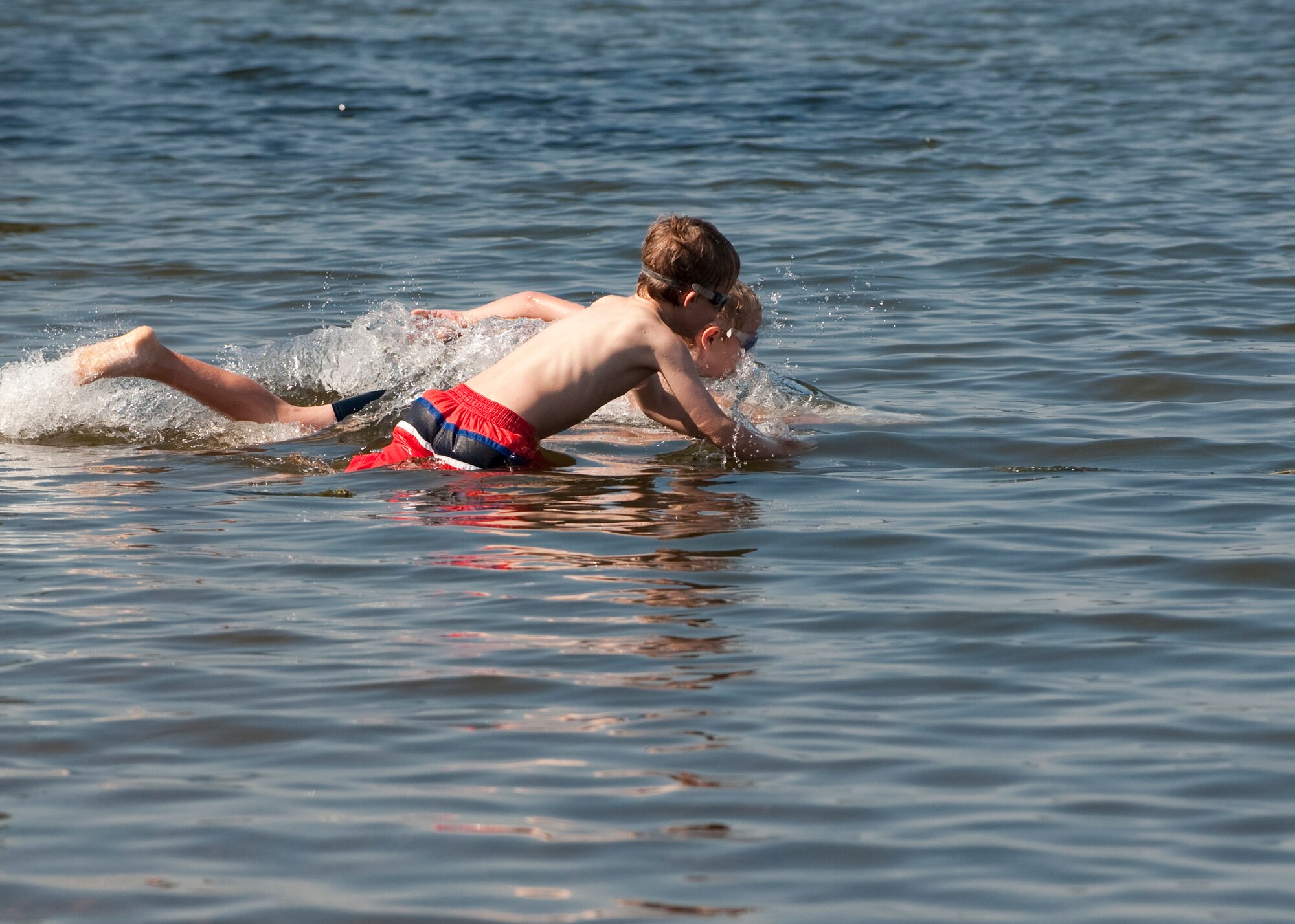 MISAWA AIR BASE, Japan -- Smith Frost and Thomas Alley start the youth triathlon during Wild Weasel Triathlon 2010 at the base beach, Aug. 21. The youth triathlon consisted of a 100-meter swim, 2K bike ride and a 1K run. Frost won the triathlon with a time of 16 minutes, 46 seconds. (U.S. Air Force photo/Staff Sgt. Samuel Morse)