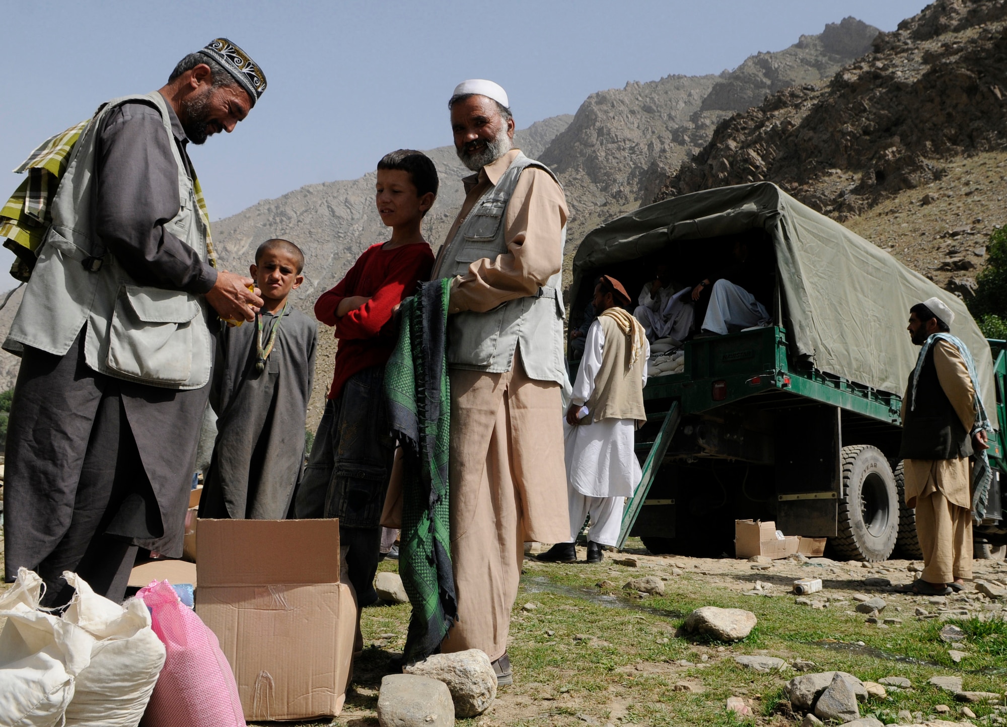 With the help of the Dara Afghan National Police, the executive district manager of the Abdullah Khel Valley in the Dara District, led the distribution of humanitarian aid consisting of food and cooking items to those affected by flooding in early August. The local government identified families requiring aid, developed a plan of distribution and executed that plan with minimal Provincial Reconstruction Team  Panjshir oversight. (U.S. Air Force photo by: Tech. Sgt. Sean Mateo White, PRT Panjshir photographer)