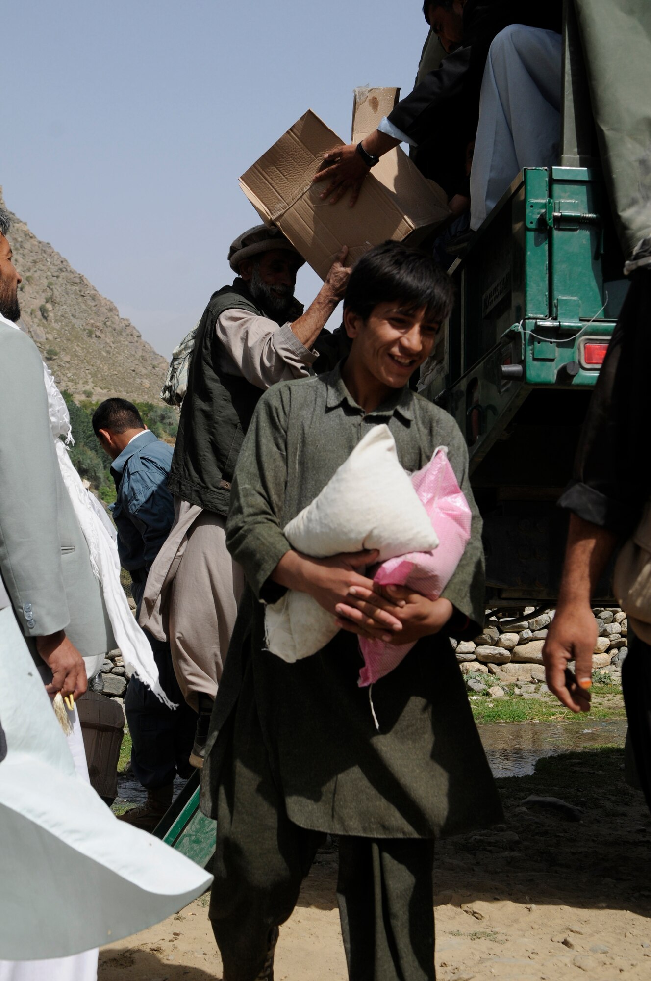 With the help of the Dara Afghan National Police, the executive district manager of the Abdullah Khel Valley in the Dara District, led the distribution of humanitarian aid to those affected by flooding in early August. The humanitarian aid consisted of essential food and household items.  The local government identified families requiring aid, developed a plan of distribution and executed the plan with minimal Provincial Reconstruction Team  Panjshir oversight. (U.S. Air Force photo by: Tech. Sgt. Sean Mateo White, PRT Panjshir photographer)