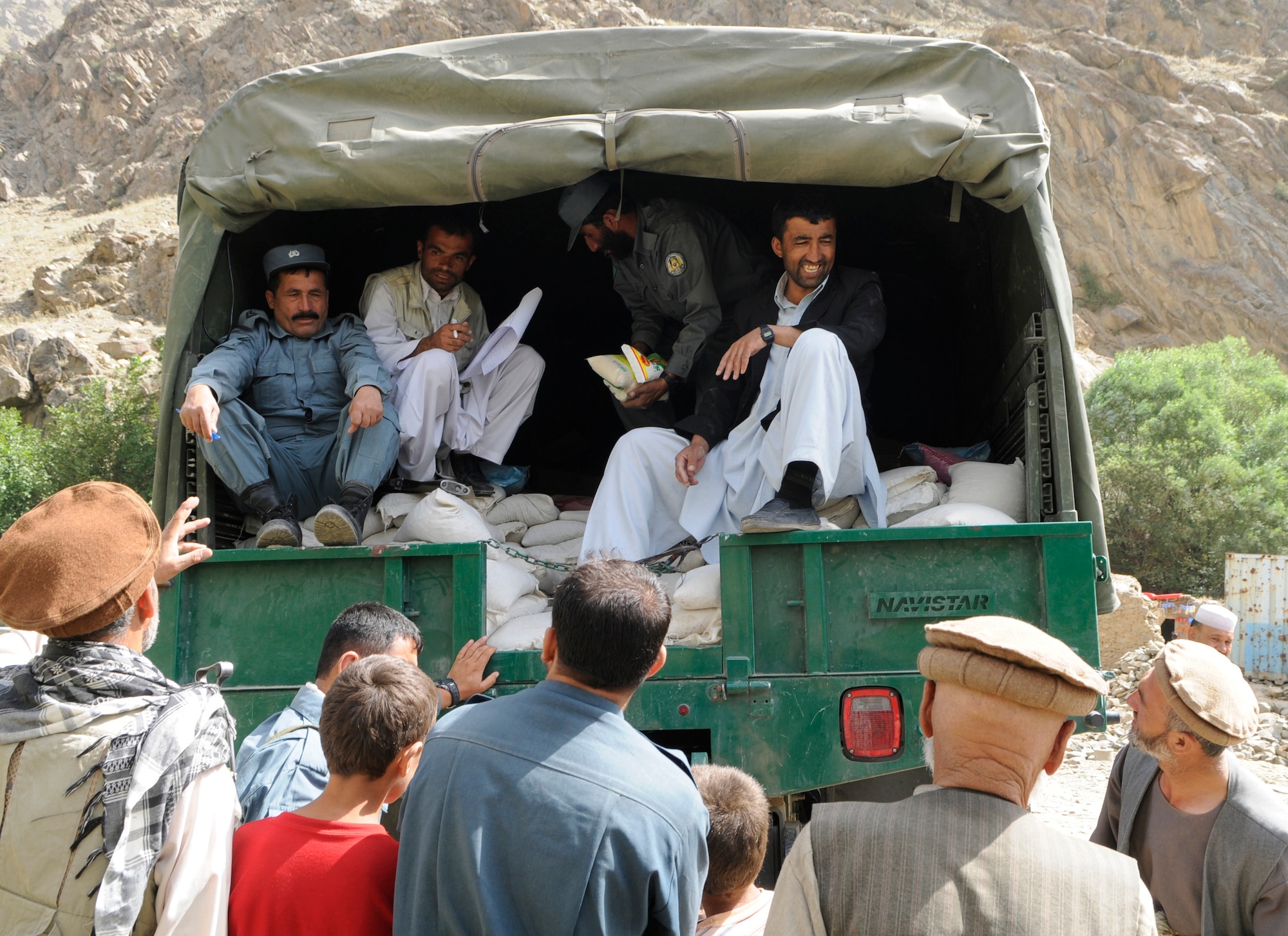With the help of the Dara Afghan National Police, the executive district manager of the Abdullah Khel Valley in the Dara District, led the distribution of humanitarian aid to those affected by flooding in early August. The humanitarian aid consisted of essential food and household items.  The local government identified families requiring aid, developed a plan of distribution and executed the plan with minimal Provincial Reconstruction Team  Panjshir oversight. (U.S. Air Force photo by: Tech. Sgt. Sean Mateo White, PRT Panjshir photographer)