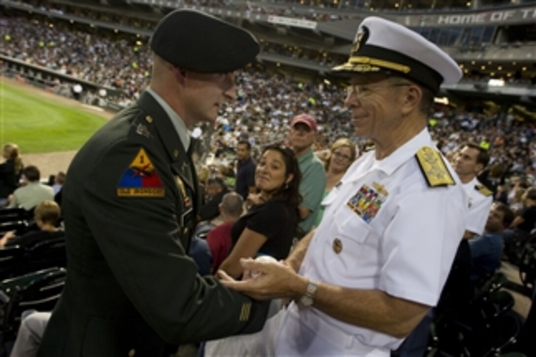 Chairman of the Joint Chiefs of Staff Adm. Mike Mullen, U.S. Navy, greets U.S. Army Capt. Scott Leifker during the Chicago White Sox versus the Baltimore Orioles game at U.S. Cellular Field on Aug. 25, 2010.  Leifker was severely burned in a car bomb explosion in Iraq in 2006.  Mullen is on a three-day Conversation with the Country tour to the Midwest meeting with local civic and business leaders discussing the needs of returning troops, their families and how community leaders can support them.  