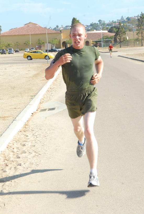 Recruit Matthew Cannon, Platoon 1049, Company C., pushes hard toward the finish line completeing his three-mile run for the final PFT.