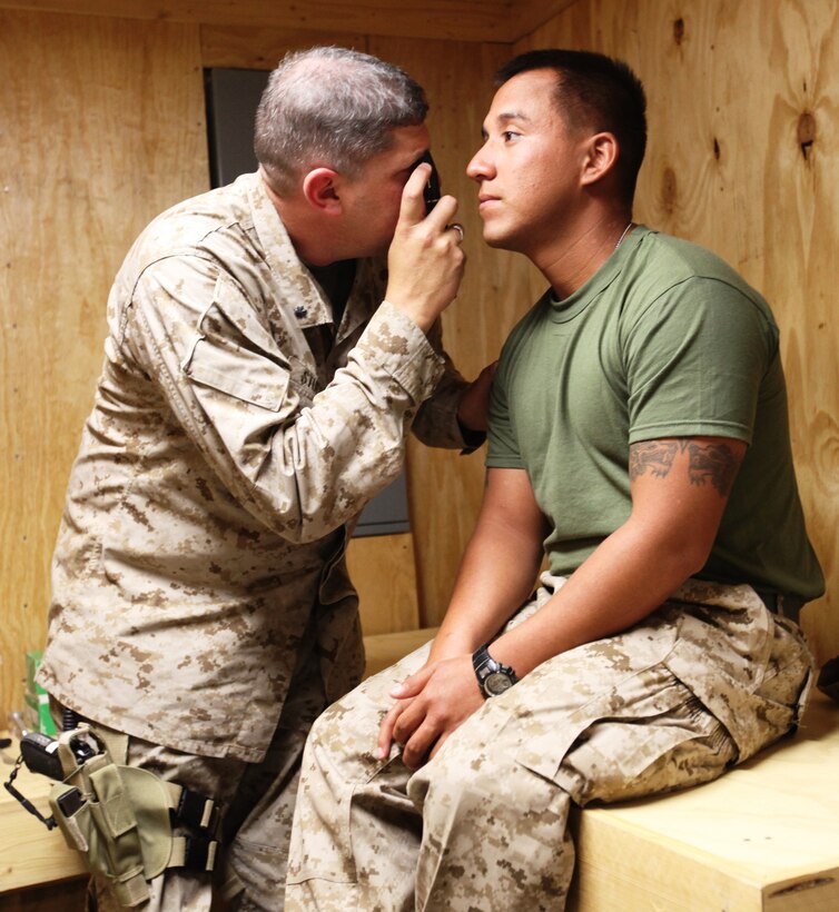 Cmdr. Keith Stuessi, a family physician with the Concussion Restoration Care Center, examines Sgt. Gorge Segura, artilleryman with India Battery, 1st Battalion, 11th Marine Regiment, at Camp Leatherneck, Afghanistan, Aug. 26. Segura, 25, from San Angelo, Texas, suffered a grade-two concussion when a 100-pound roadside bomb exploded 30 meters away from him during a foot patrol in the Kajaki region of northern Helmand Province. The newly-opened concussion center opened Monday and was developed to aid in the treatment of service members who suffer from concussions, the number-one battle injury. The clinic is a first-of-its-kind facility in Helmand Province that was developed to aid in the treatment of concussions as well as musculo-skeletal injuries commonly caused by improvised explosive device blasts.