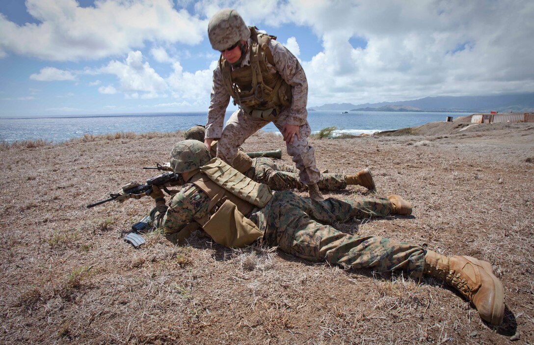 Staff Sgt. Michael Wissmeyer, staff noncommissioned officer in charge of Infantry Squad Leader Course, School of Infantry West — Detachment Hawaii, clears out ISLC students’ weapons following a live fire and maneuver assault at Range Training Facility Kaneohe Bay on Marine Corps Base Hawaii Aug. 26. Over ISLC’s 45 training days, the students also learn advanced patrolling, military operations in urban terrain, demolitions, land navigation, combat hunter, fire plan sketches, and conduct unit training management.