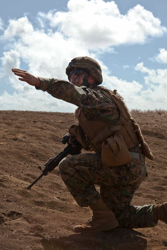 Lance Cpl. Alex Russell, a team leader with Company B, 1st Battalion, 3rd Marine Regiment, and a student of the Infantry Squad Leader Course, School of Infantry West — Detachment Hawaii, yells a command to his squad members during a live fire and maneuver assault at Range Training Facility Kaneohe Bay on Marine Corps Base Hawaii Aug. 26. “The mission of the Infantry Squad Leader Course is to give Marines the technical and tactical tools to begin leading their squad when they get back to the fleet,” said Staff Sgt. Eric Ciotola, chief instructor, ISLC. “It’s the best leadership school an infantry Marine can go through.”