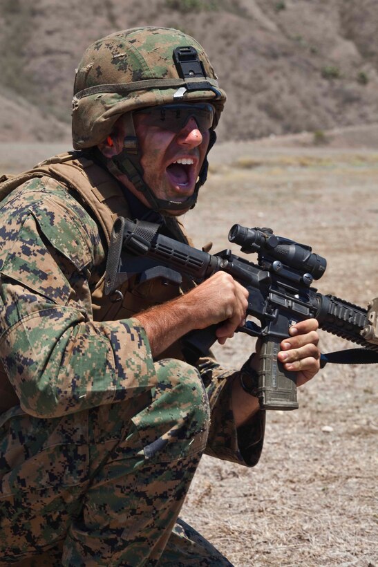 Lance Cpl. Justin Dahme, a team leader with Weapons Company, 1st Battalion, 3rd Marine Regiment, and student with the Infantry Squad Leader Course, School of Infantry West — Detachment Hawaii, shouts commands to his squad during a live fire and maneuver assault at Range Training Facility Kaneohe Bay on Marine Corps Base Hawaii Aug. 26. The challenging 45-training-day course, run out of School of Infantry West — Detachment Hawaii, provides infantrymen the technical and tactical tools to begin leading squads of Marines in the fleet.