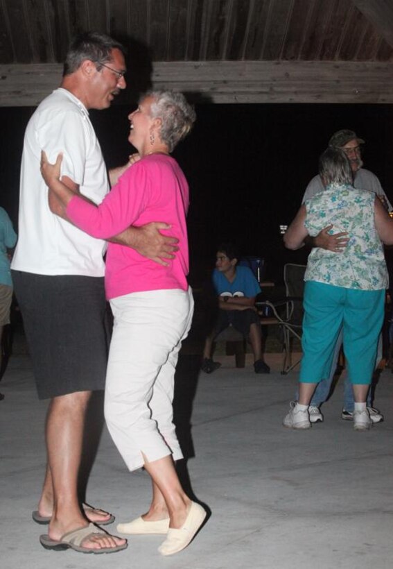 Couples dance during the last Flashback Fridays party of the summer at the Onslow Beach Gazebo, aboard Marine Corps Base Camp Lejeune, Aug. 27. The party was themed “Good Vibrations” and featured tunes from the 1950s, 1960s and 1970s.