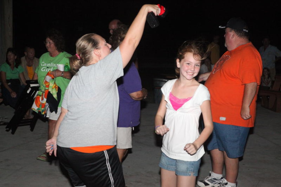 Madelin Howell (right), a military dependent, shows her moves during the last Flashback Fridays party of the year at the Onslow Beach Gazebo, aboard Marine Corps Base Camp Lejeune, Aug. 27. Service members, family and friends gathered for a night of fun, music and camaraderie.