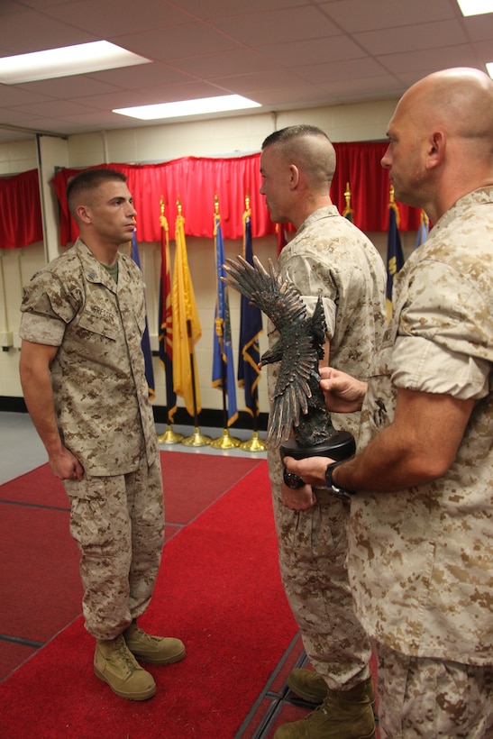 Sgt. Daniel D. Gresser stands at attention in front of the Center for Naval Aviation Technical Training commanding officer, Lt. Col. Paul M. Melchior, and CNATT Sgt. Maj. M. E. Sprague to receive the Navy and Marine Association Leadership Award in the CNATT graduation room Aug. 27. Gresser is an aviation ordnance instructor at CNATT.