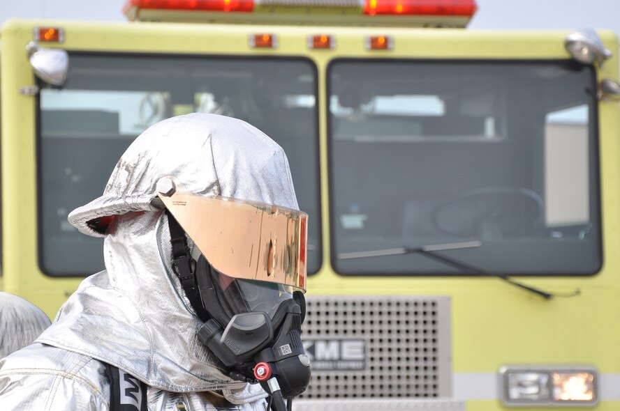 A firefighter from the 934th Airlift Wing, stands ready to respond during a simulated C-130 Hercules fire March 7 2010. (Air Force Photo/TSgt Bob Sommer)