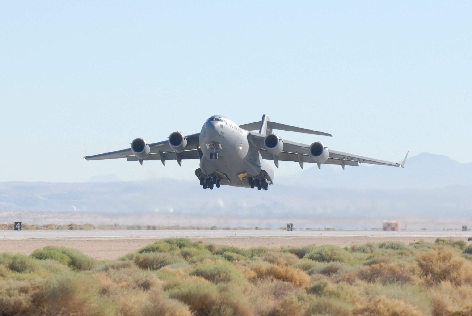 An Edwards' based C-17 Globemaster III takes off Aug. 27 to conduct a flight test to see how it performs with different combinations of biofuels.  The aircraft was powered by 50-percent JP-8, 25-percent hydro-treated renewable jet fuel and 25-percent of a Fischer–Tropsch fuel.  The 418th Flight Test Squadron conducted flight tests during the week using different combinations of regular JP-8 and the HRJ.  (Air Force photo by Kenji Thuloweit)