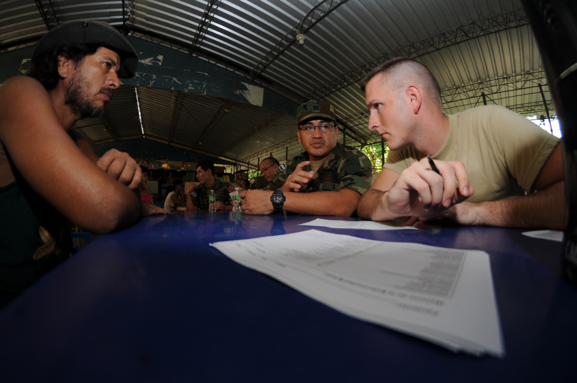 SAN CARLOS LEMPA, El Salvador --  Working with an El Salvador military medic, Staff Sgt. John Bartlett, with the Joint Task Force-Bravo Medical Element, screens patients during the medical civic action program here Aug. 25. Team Bravo medical professinals assisted the El Salvador Ministry of Health and military in treating almost 800 patients here. (U.S. Air Force photo/Tech. Sgt. Benjamin Rojek)