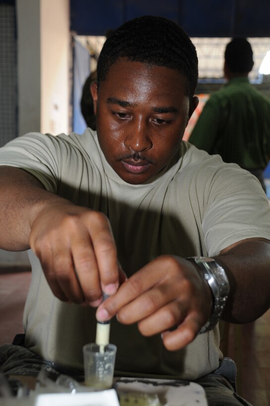 SAN CARLOS LEMPA, El Salvador --  Preparing medications, Tech. Sgt. Michael Morrison, with the Joint Task Force-Bravo Medical Element, assists in the pharmacy during the medical civic action program here Aug. 25. Team Bravo medical professinals assisted the El Salvador Ministry of Health and military in treating almost 800 patients here. (U.S. Air Force photo/Tech. Sgt. Benjamin Rojek)