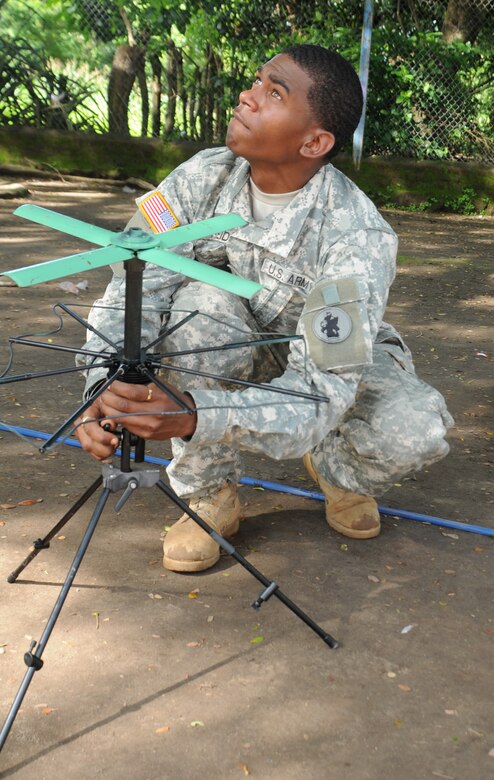 EL PICHICHE, El Salvador --  Ensuring there is no tree cover overhead, Spc. Ahkeel Reid, with the Joint Task Force-Bravo Army Forces, sets up communications systems during the medical civic action program here Aug. 24. Communications specialists ensured the JTF-Bravo Medical Element personnel were in contact with weather specialists and the flight crew during their mission here. (U.S. Air Force photo/Tech. Sgt. Benjamin Rojek)