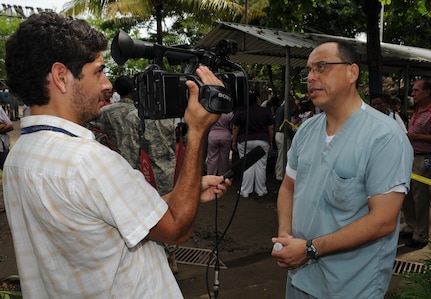 EL PICHICHE, El Salvador -- A journalist, left, interviews Dr. Guillermo Saenz, a Joint Task Force-Bravo Medical Element liaison officer, during the medical civic action program here Aug. 24. Dr. Saenz and other Team Bravo members assisted the El Salvador Ministry of Health and military in bringing medical care to this remote village. (U.S. Air Force photo/Tech. Sgt. Benjamin Rojek)