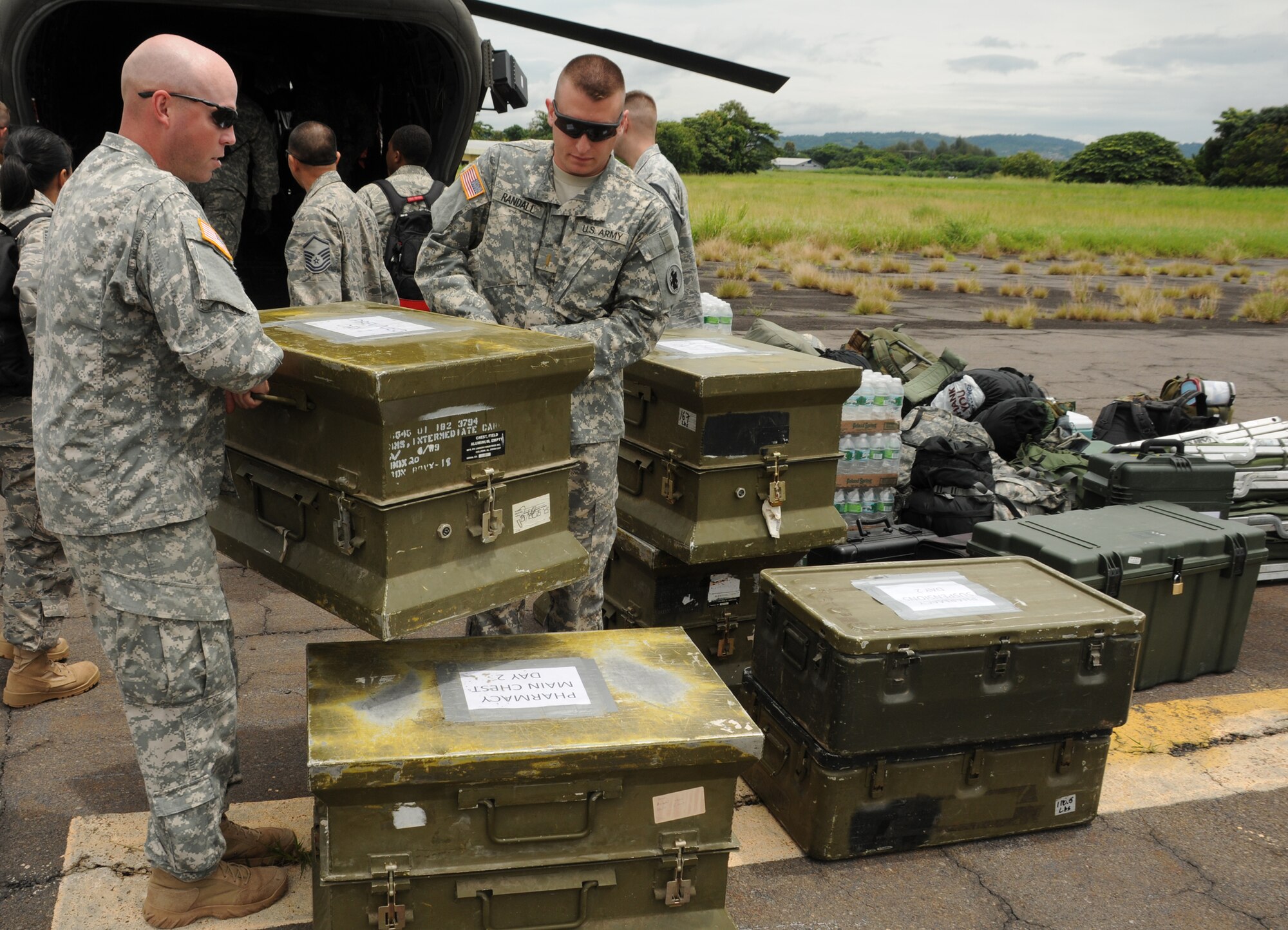 ILAPONGO AIR BASE, El Salvador --  Spc. Christopher Black, with the Joint Task Force-Bravo Medical Element, and 2nd Lt. Joshua Randall, with JTF-Bravo J6, help unload medical and personal supplies after arriving here Aug. 23 for a medical civic action program. The Team Bravo members assisted the El Salvador Ministry of Health and military in treating more than 1,200 patients over two clinic days. (U.S. Air Force photo/Tech. Sgt. Benjamin Rojek)