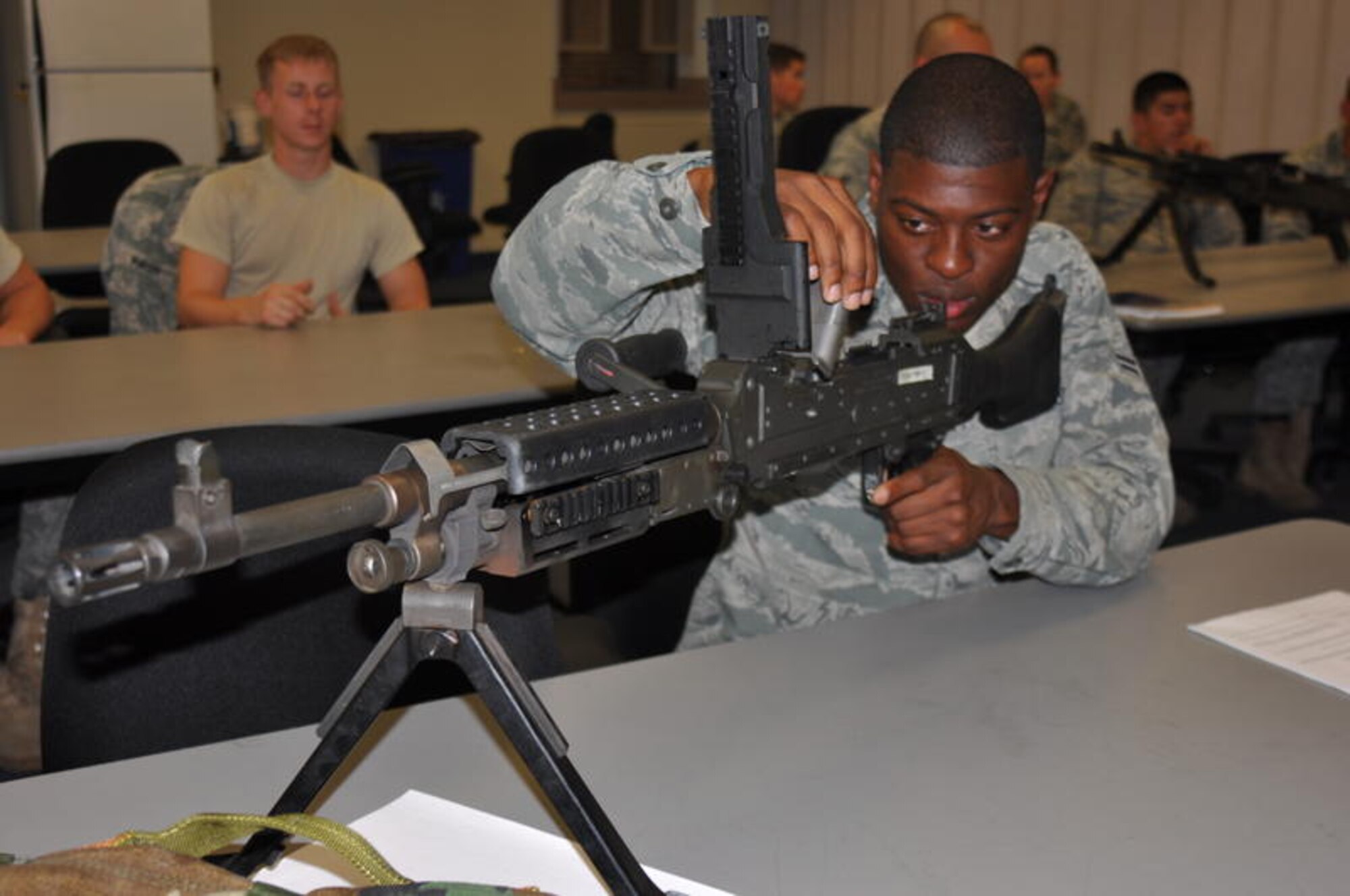 Airman from the 615th Contingency Response Wing learns heavy automatic weapon maintenance Aug. 23 in class at the Combat Arms Training and Maintenance facility. 