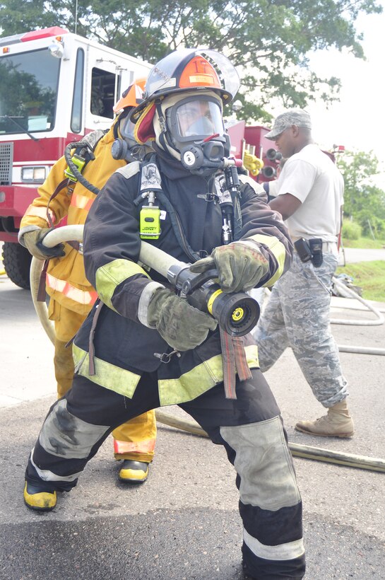 SOTO CANO AIR BASE, Honduras --  Draggin a hose into place, firefighters from the 612th Air Base Squadron train with firefighters from Honduras and Guatemala during the Central America Sharing Mutual Operational Knowledge and Experiences exericse here Aug. 26. This was the first time Guatemala participated in the annual exercise. (U.S. Air Force photo/Martin Chahin)