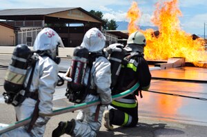 SOTO CANO AIR BASE, Honduras --  Firefighters from the 612th Air Base Squadron, Honduras and Guatemala work together to put out a blazing fire during the Central America Sharing Mutual Operational Knowledge and Experiences exercise here Aug. 24. This was the first time Guatemala participated in the annual exercise. (U.S. Air Force photo/Martin Chahin)