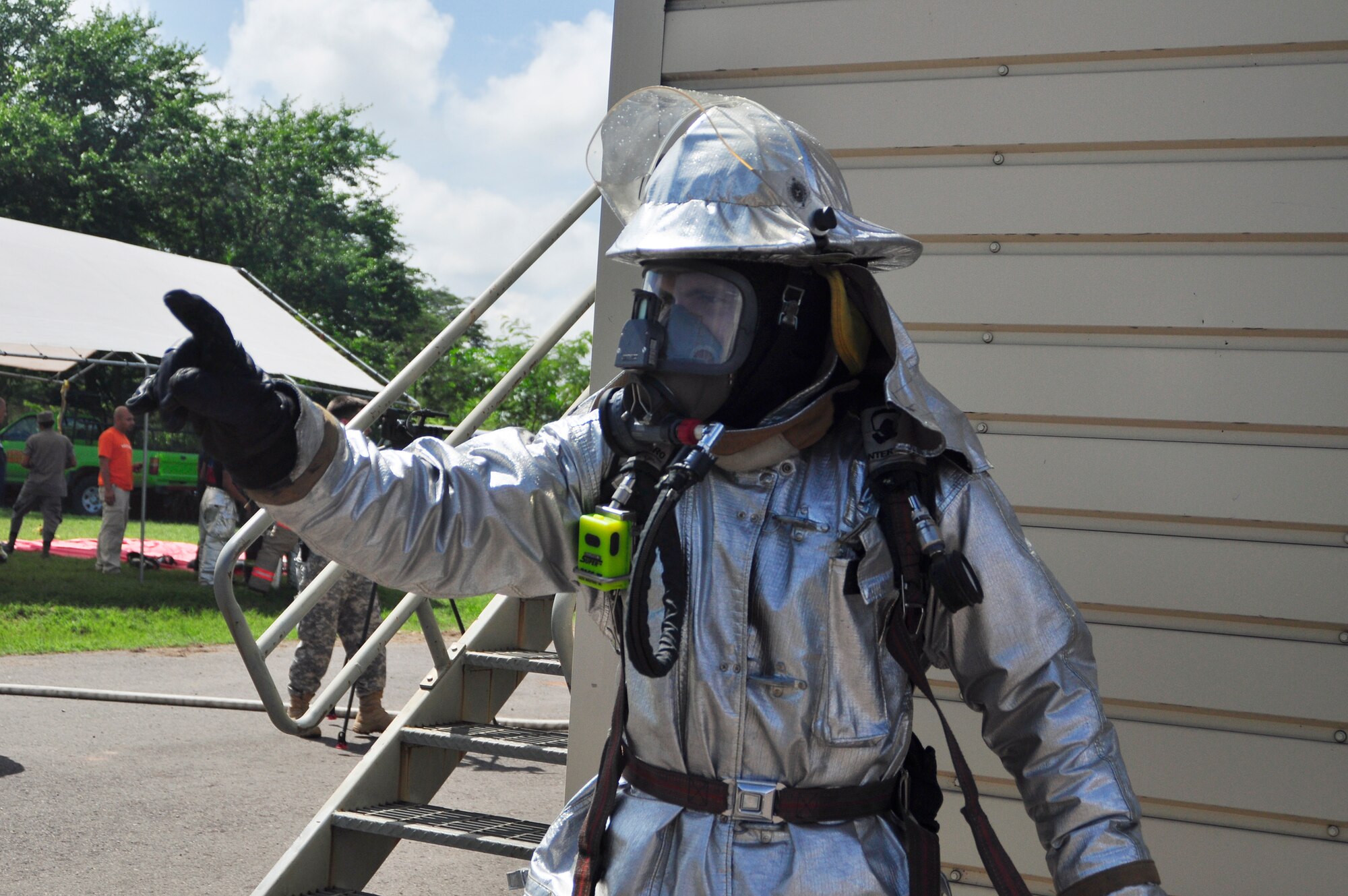 SOTO CANO AIR BASE, Honduras --  Mr. Herberth Gaekel, a 612th Air Base Squadron fire inspector, directs his fellow teammembers during the Central America Sharing Mutual Operational Knowledge and Experiences exericse here Aug. 26. This year's firefighter training exercise included firefighters from Honduras, the 612th Air Base Squadron and, for the first time, Guatemala. (U.S. Air Force photo/Martin Chahin)