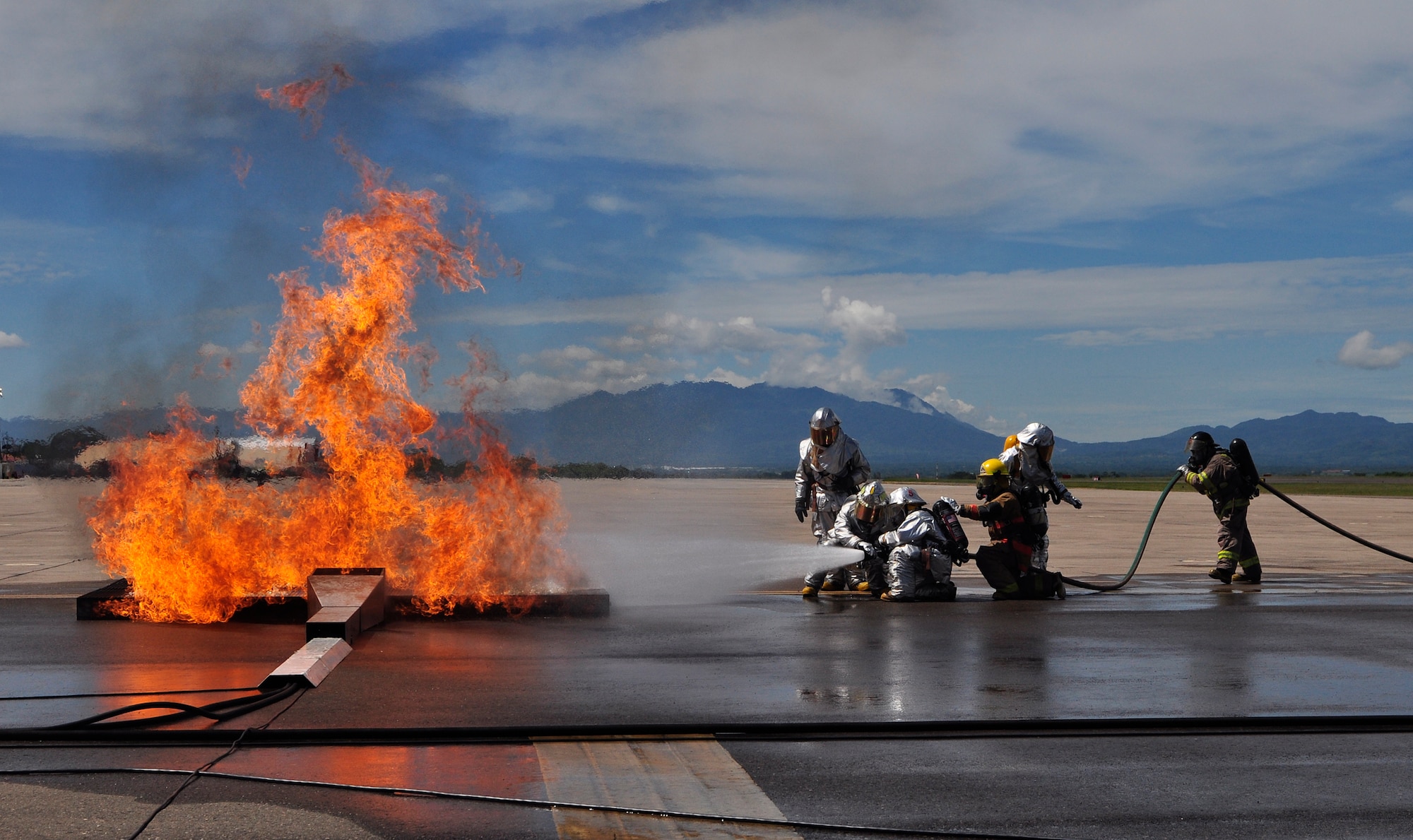 SOTO CANO AIR BASE, Honduras --  Firefighters from the 612th Air Base Squadron, Honduras and Guatemala work together to put out a blazing fire during the Central America Sharing Mutual Operational Knowledge and Experiences exericse here Aug. 24. This was the first time Guatemala participated in the annual exercise. (U.S. Air Force photo/Martin Chahin)