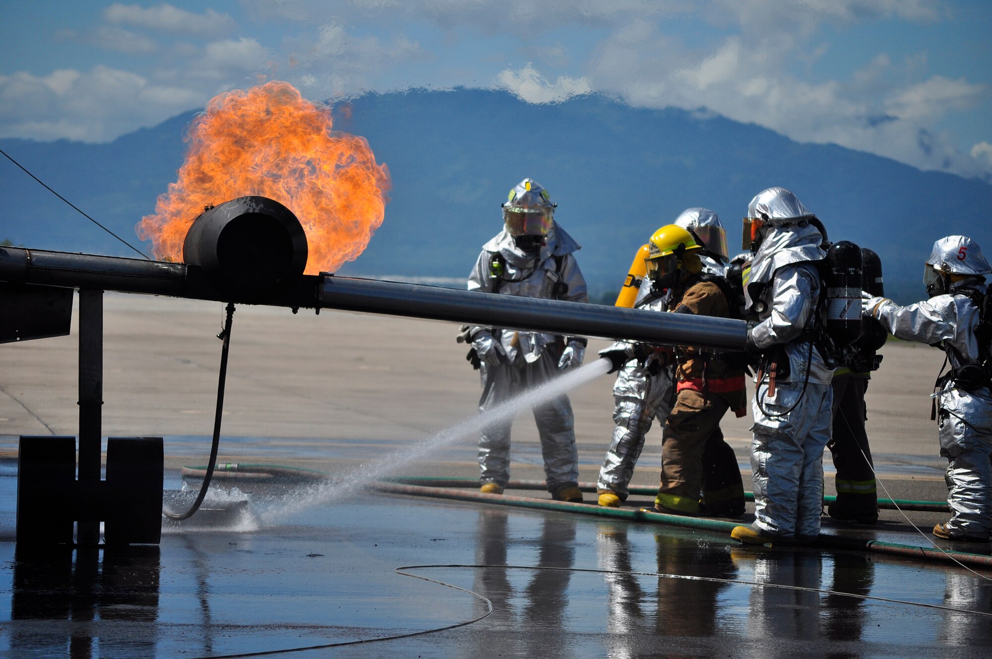 SOTO CANO AIR BASE, Honduras --  As the fire rages from an "aircraft engine," firefighters from the 612th Air Base Squadron train with firefighters from Honduras and Guatemala during the Central America Sharing Mutual Operational Knowledge and Experiences exericse here Aug. 24. This was the first time Guatemala participated in the annual exercise. (U.S. Air Force photo/Martin Chahin)