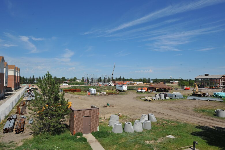 MINOT AIR FORCE BASE, N.D. – Construction of a new dorm is ongoing, while a dorm on the right is getting demolished and the new dorms are on the left at Minot Air Force Base, N.D., July 27. This is one of the many constructions to improve the quality of life for single Airmen around Eighth Air Force. (U.S. Air Force photo by Master Sgt. Michael Gaddis)