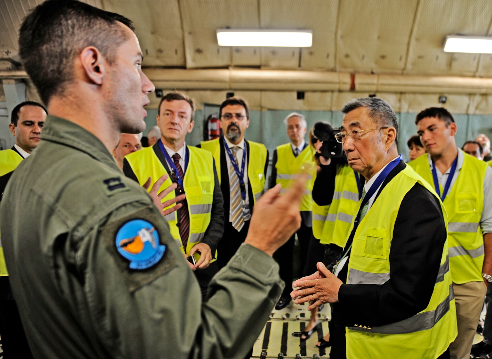 Capt. Cory Damon speaks to scientists and engineers about the C-5M Super Galaxy Aug. 25, 2010, at the Geneva airport. Captain Damon is a C-5M pilot assigned to the 9th Airlift Squadron at Dover Air Force Base, Del. (U.S. Air Force photo/Staff Sgt. Ryan Crane)