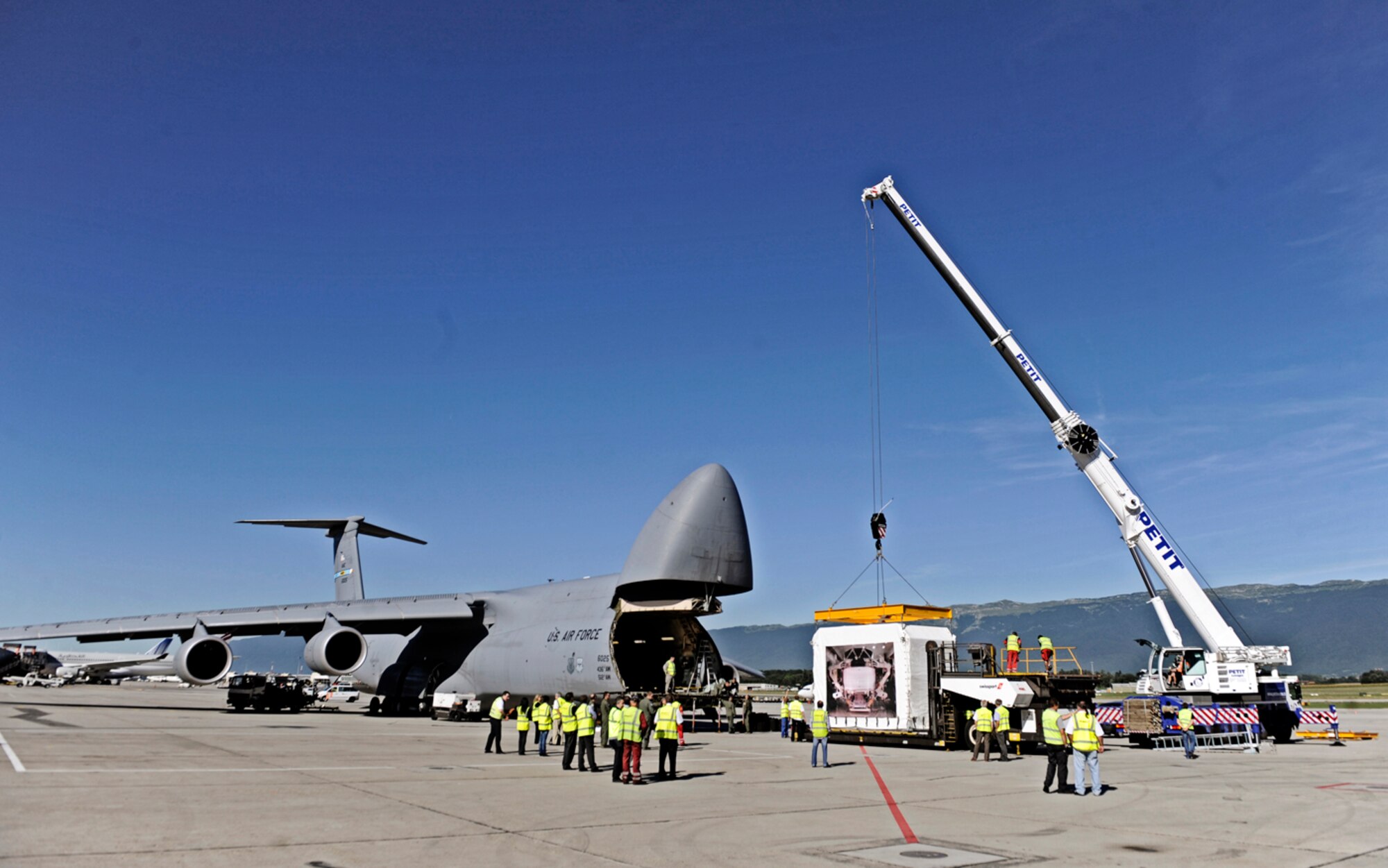 A C-5M Super Galaxy is loaded with the Alpha Magnetic Spectrometer Aug. 25, 2010, at the Geneva airport. The AMS is the brain child of Nobel laureate Dr. Samuel Ting and has been in production for 16 years. The purpose of the device is to detect and analyze particles found in space while docked to the International Space Station. The C-5M is based out of Dover Air Force Base, Del. (U.S. Air Force photo/Staff Sgt. Ryan Crane)