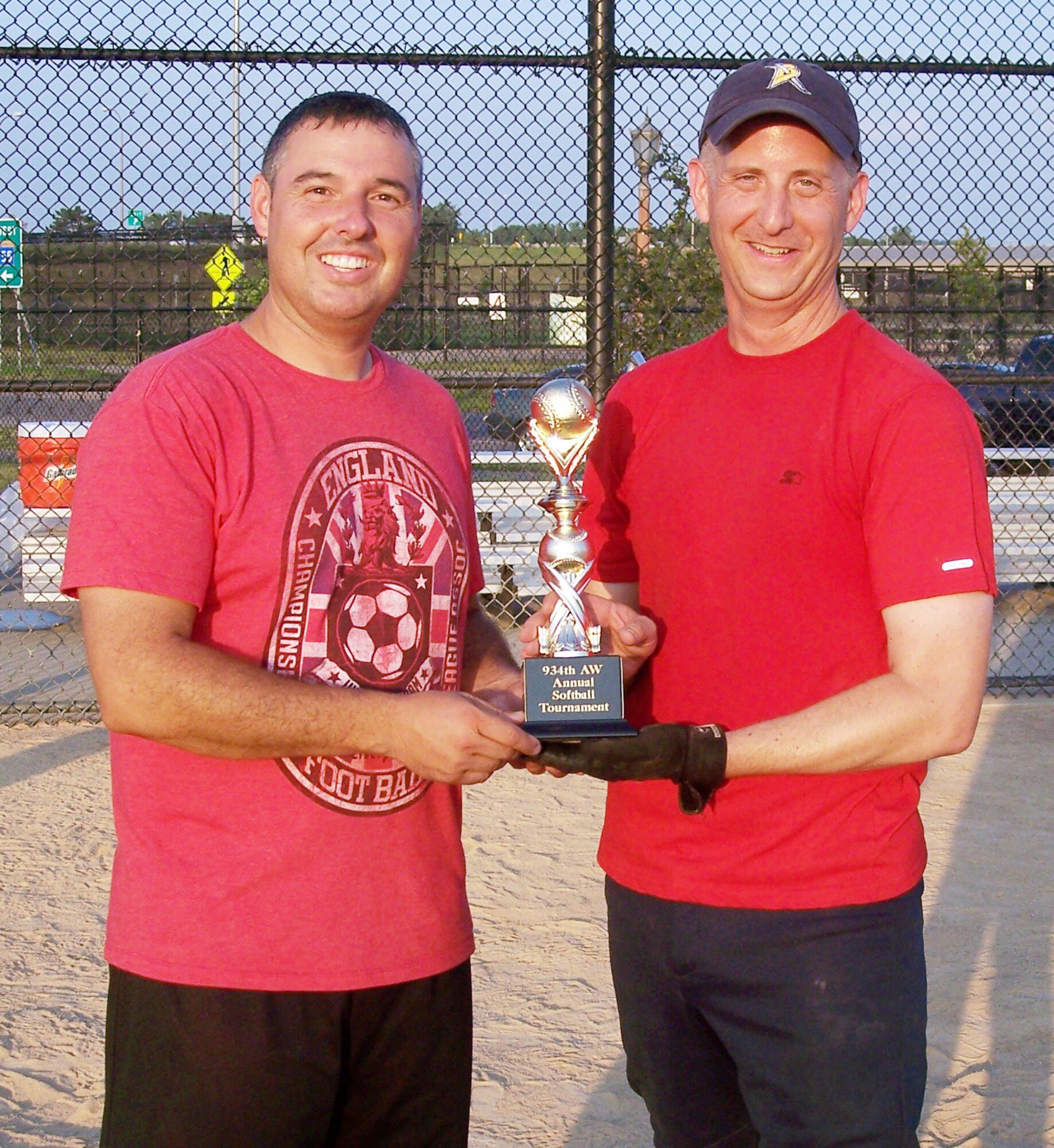 Master Sgt. Andreas Regal, 934th Services Squadron (left) presents the first 934th Airlift Wing softball championship trophy to Col. Brett Newman, 934th Maintenance Group commander.  The MXG won the tournament Aug. 7. (Courtesy Photo)