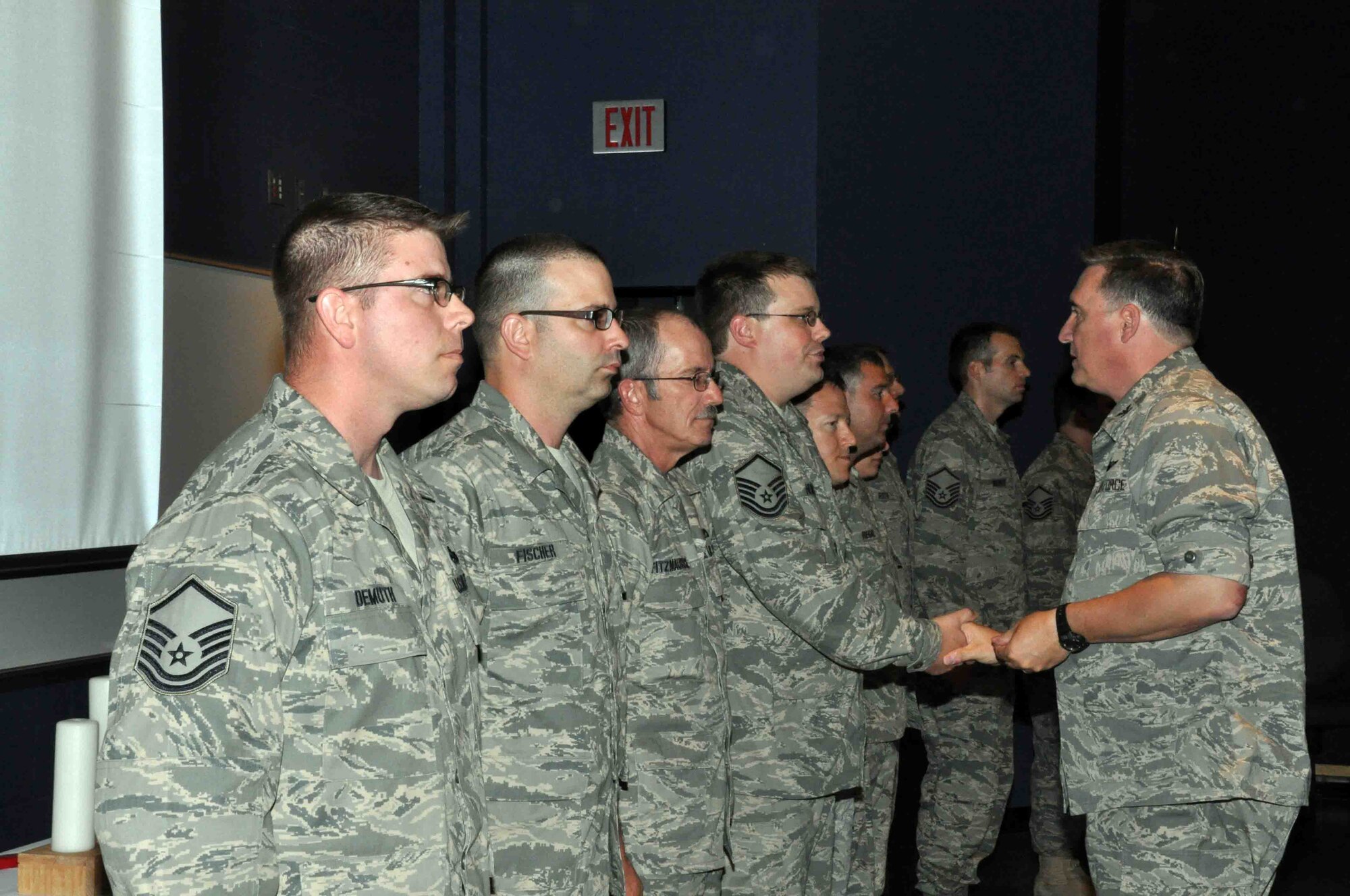 Col. Darrell G. Young, 934th Airlift Wing commander, congratulates new NCOs and Senior NCOs at the Wing NCO recognition ceremony Aug. 7. (Air Force Photo/Capt. S.J. Brown.)