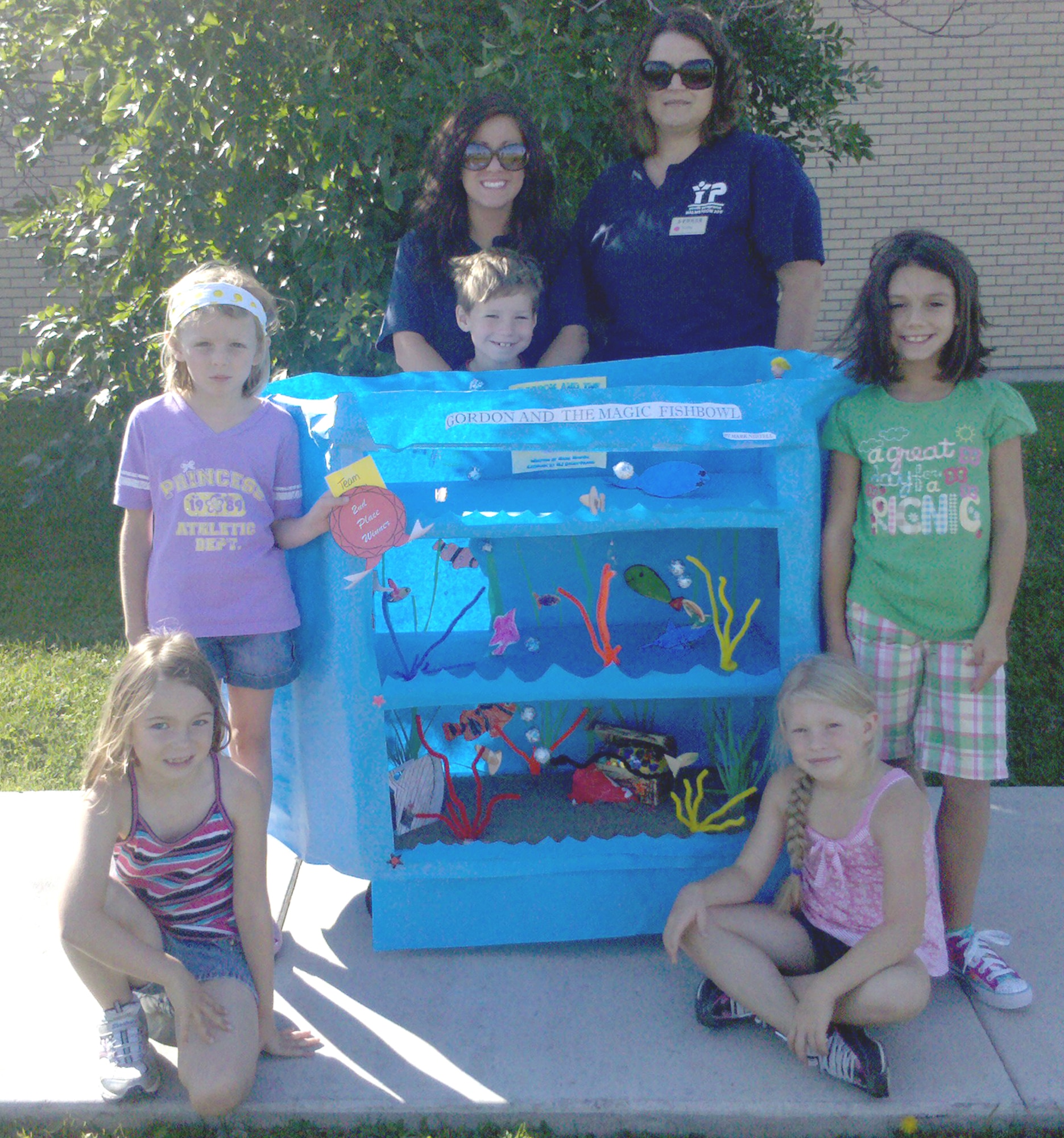 Team Fish Bowl came in second place in the Summer Reading Program's Book Cart Decorating Contest with the Youth Center. Pictured here clockwise from top left: Kaitlynn Bratten, Riley Wolfe, Ms. Deziree Weileman, Ms. Kathy Miller, Jordyn McMullin, Schauntae Simons and Christina Sylva.