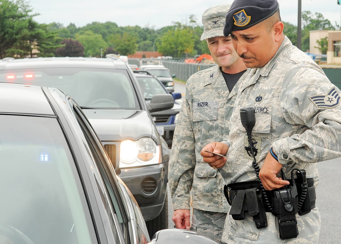 JOINT BASE ANDREWS, Md. -- Staff Sgt. Raymond Vialpando, 316th Security Forces Squadron patrolman, and Col. Ken Rizer, 316th Wing/Joint Base Andrews commander, perform a traffic stop at Joint Base Andrews Aug. 24. Colonel Rizer rode along with security forces members to observe procedures. (U.S. Air Force photo by Senior Airman Melissa Brownstein)