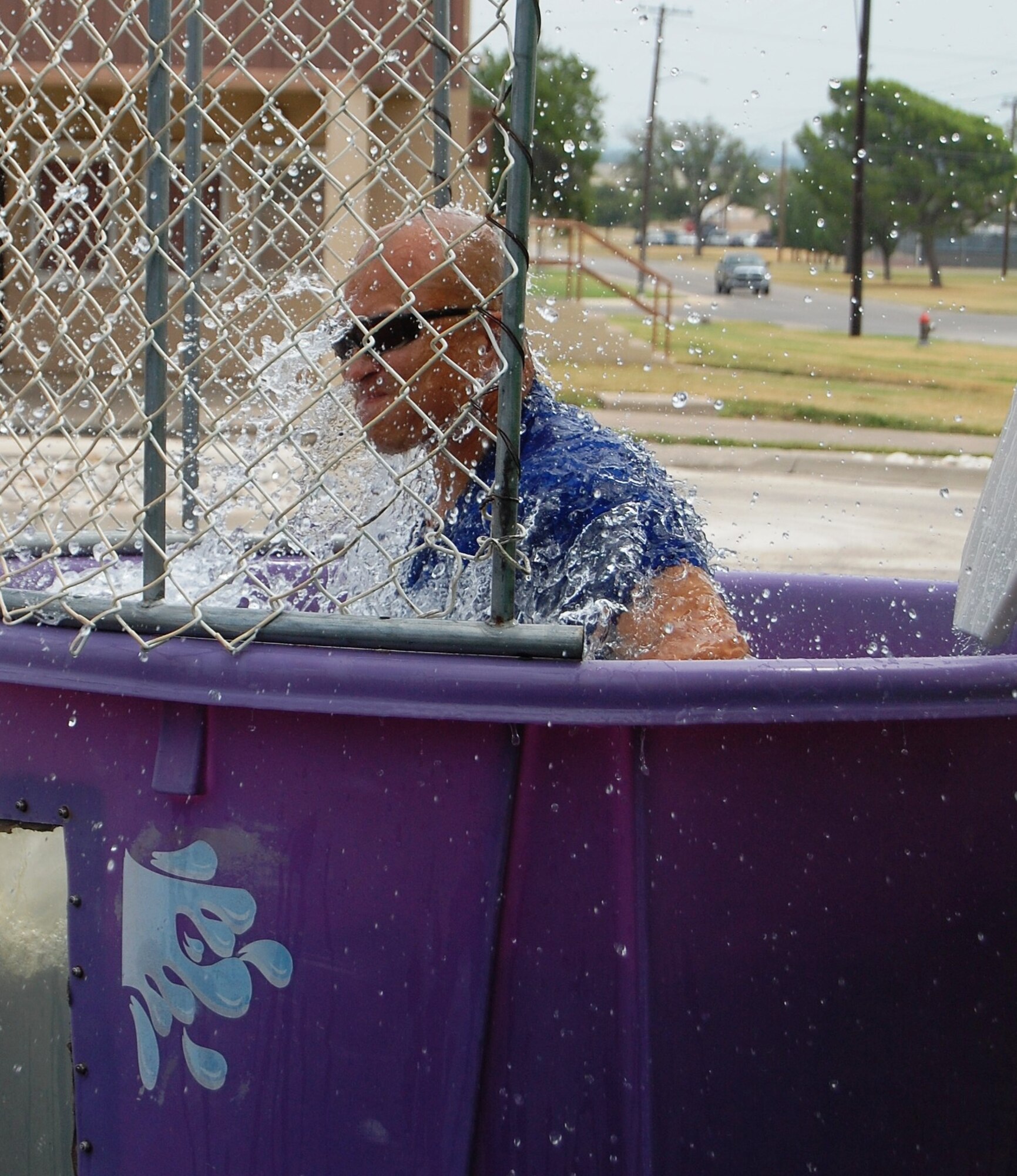LAUGHLIN AIR FORCE BASE, Texas – Master Sgt. James Escher, 47th Security Forces Squadron, holds his breathe on his way into the dunk tank Aug. 26 during a “Burger Burn” at the Laughlin Chapel. Sergeant Escher is the first sergeant in SFS and with the help of other first sergeants across the base helped support the Chapel’s function. (U.S. Air Force Photo/ Staff Sgt. Desiree Economides)
