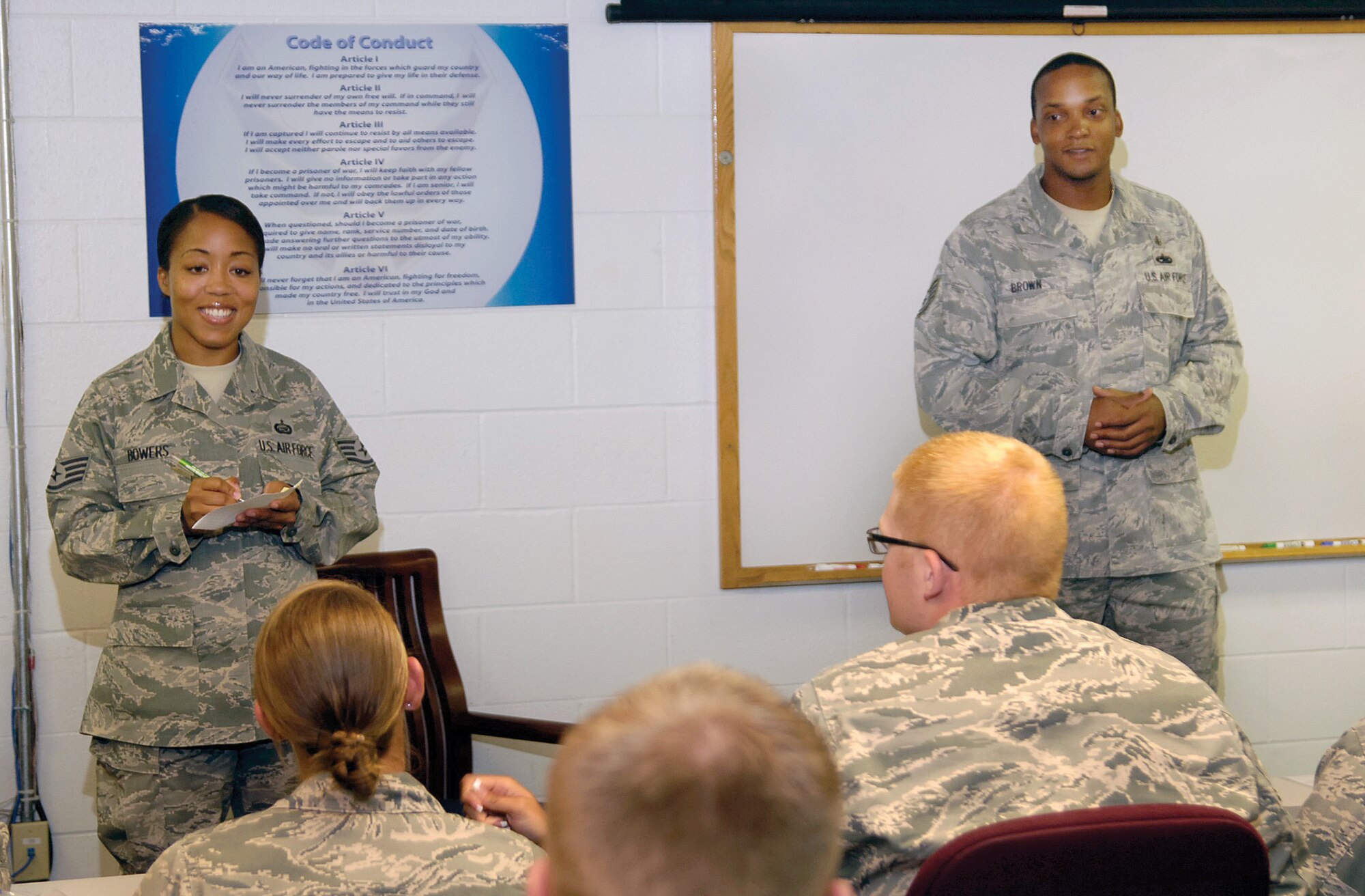 Staff Sgt. Rachel Bowers and Tech. Sgt. Trenell Brown speak to a group of Airmen who live in Tinker’s unaccompanied housing, or dorms. The sergeants are part of a team of dorm managers who are there to help meet Airmen’s needs. (Air Force photo by Margo Wright)