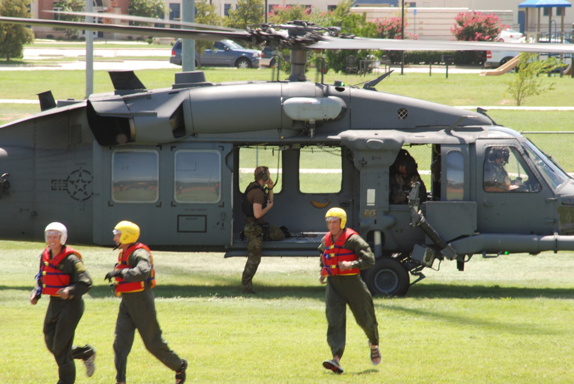 Pilots from the 457th Fighter Squadron, 301st Fighter Wing at Naval Air Station Fort Worth Joint Reserve Base, Texas, Exit their "Pavehawk" from the 306th Rescue Squadron, Davis-Monthan Air Force Base, Ariz., July 11 after completion of water extraction training. This water extraction training is the first time 457th Fighter Squadron pilots will experience rescue via an actual HH-60 "Pavehawk." (U.S. Air Force Photo/ SSgt Chris Bolen)