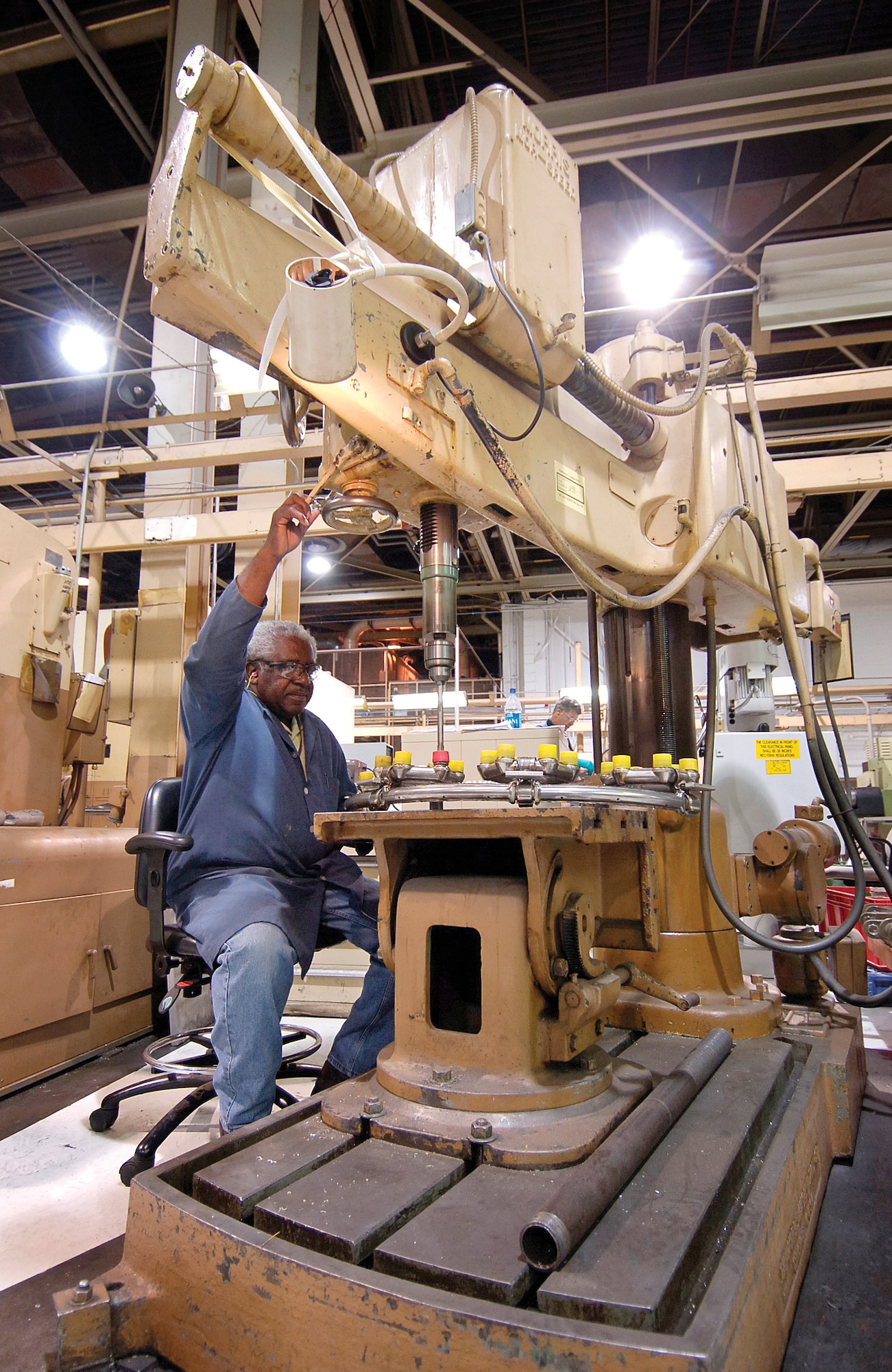 Gasoline was 32 cents a gallon and a car could set you back $2,650 when Tinker invested money for this drill press put into service in 1966. John Hones, a machinist in Bldg. 3001’s General Machine Shop, sits at the heavy metal machine. (Air Force photo by Margo Wright)