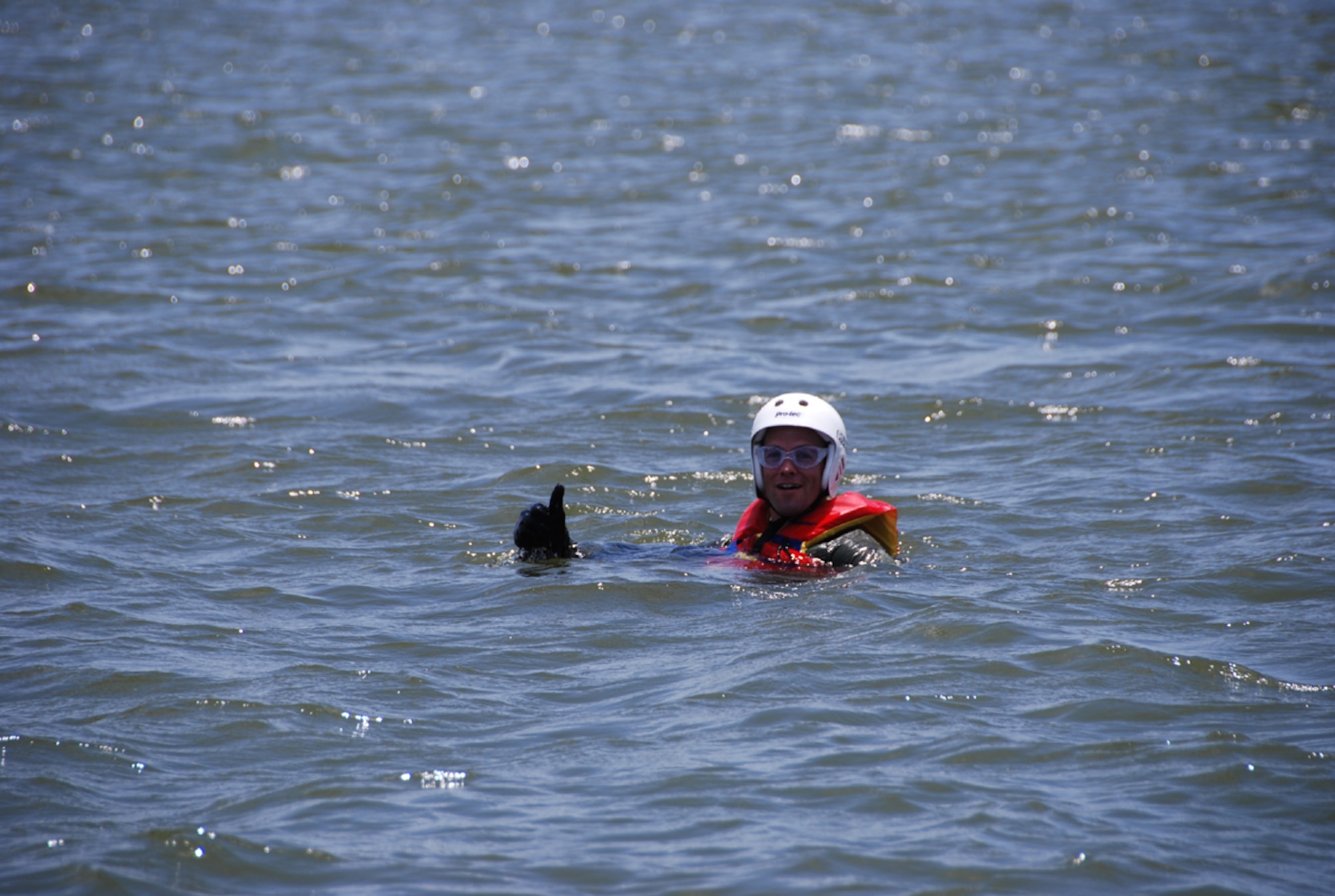 A pilot from the 457th Fighter Squadron, 301st Fighter Wing at Naval Air Station Fort Worth Joint Reserve Base, Texas, awaits "rescue" by members of the
305th and 306th Rescue Squadron July 11 during water extraction training. This water extraction training is the first time 457th Fighter Squadron pilots will experience rescue via an actual HH-60 "Pavehawk." (U.S. Air Force Photo/SrA Jeremy Roman)
